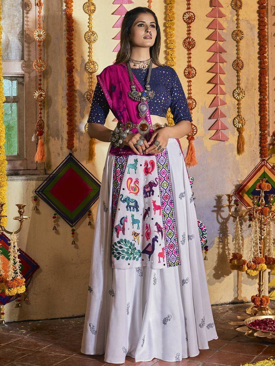 Woman in colorful Indian ethnic lehenga choli with animal embroidery, traditional jewelry, festive decor