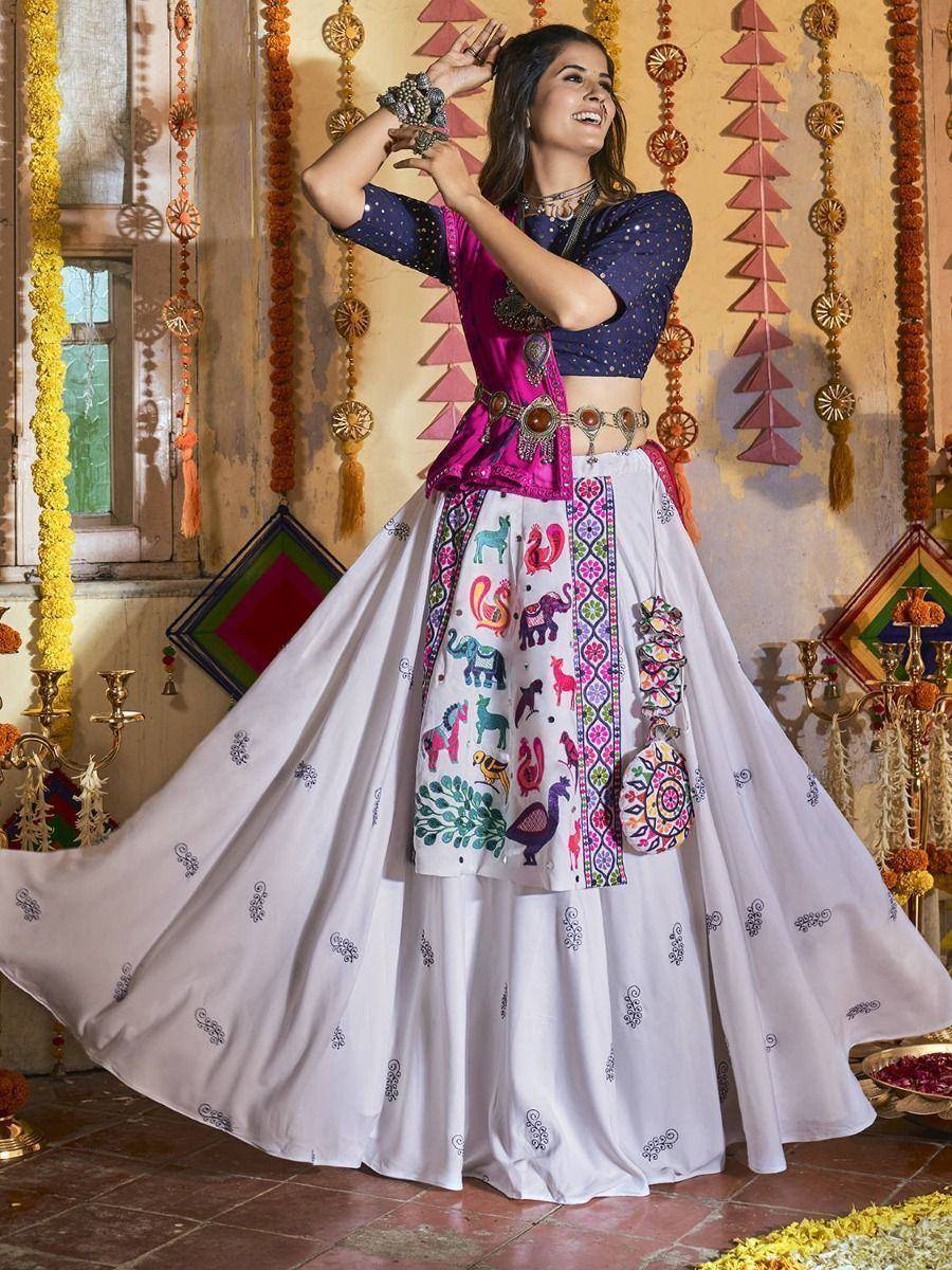 Woman in colorful Indian lehenga choli with animal embroidery, festive ethnic wear for celebrations