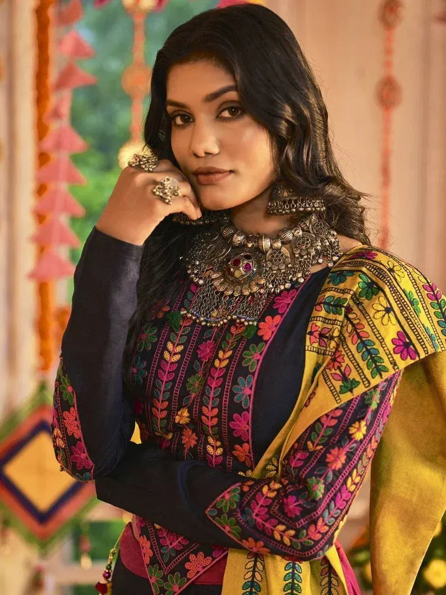 Woman in colorful embroidered ethnic kurti with statement jewelry, perfect for Indian festive wear