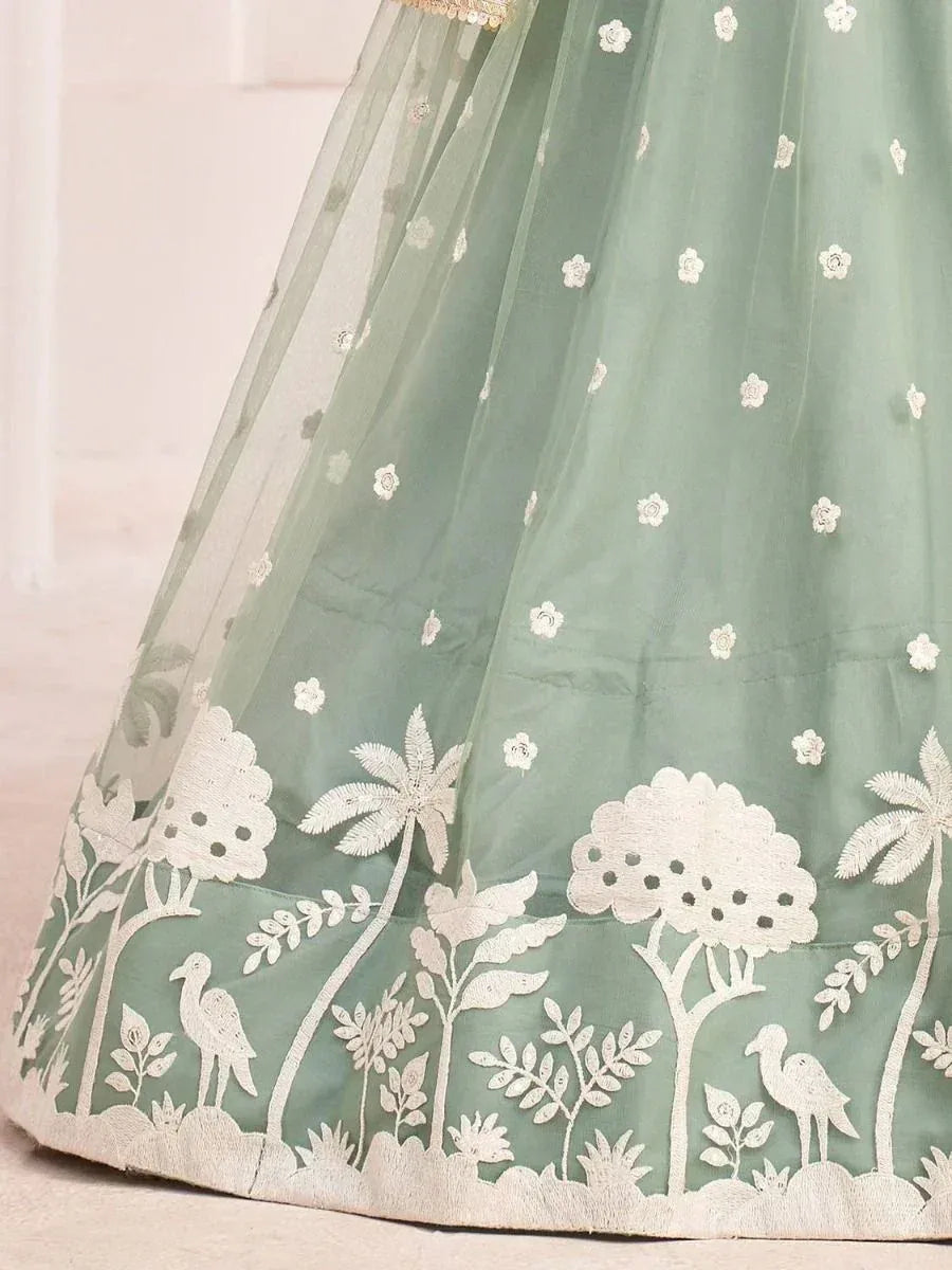 Mint green lehenga with white floral and bird embroidery, perfect for Indian ethnic wear occasions.