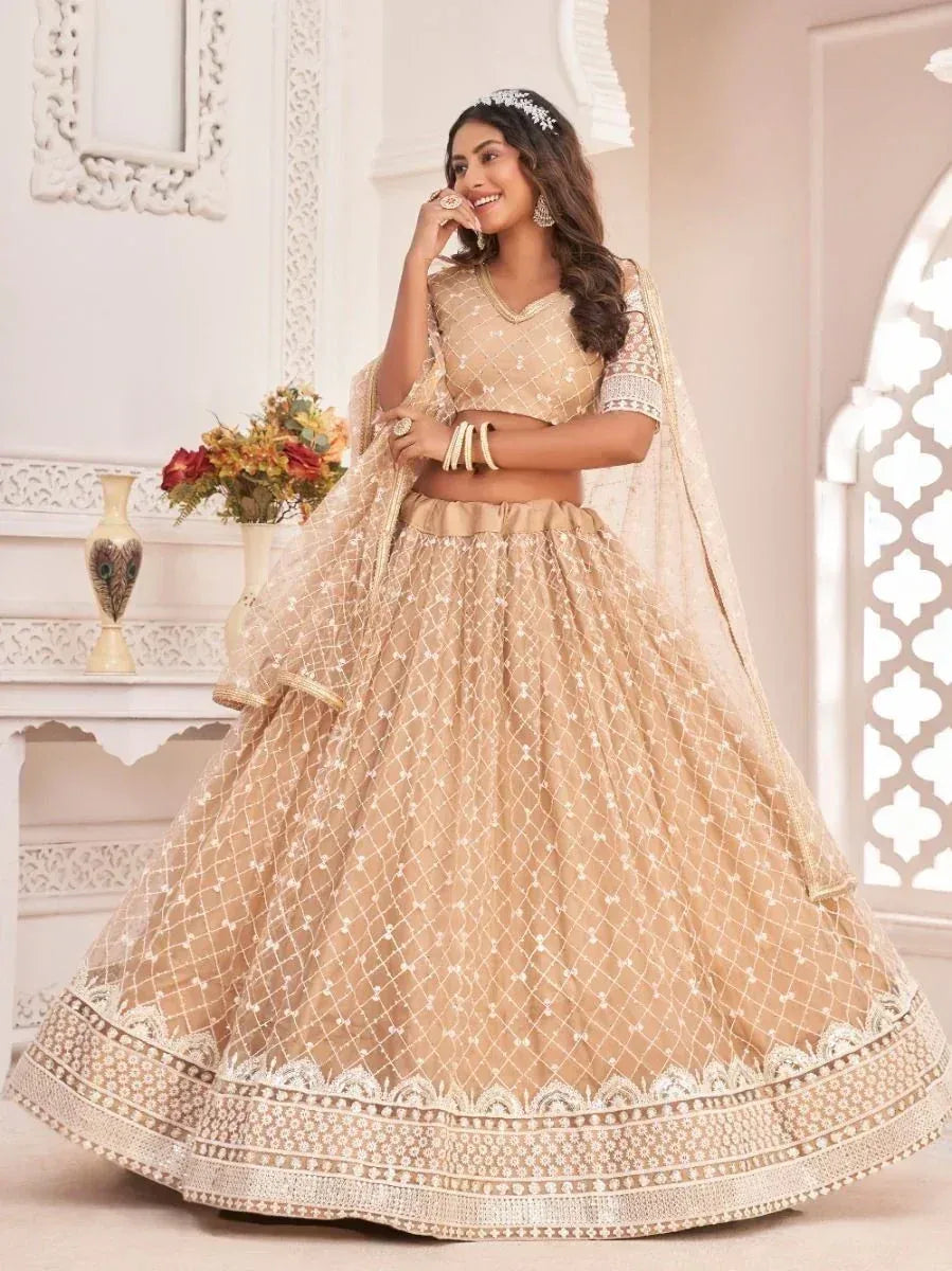 Beige designer lehenga choli with intricate white embroidery and net dupatta, perfect for Indian weddings
