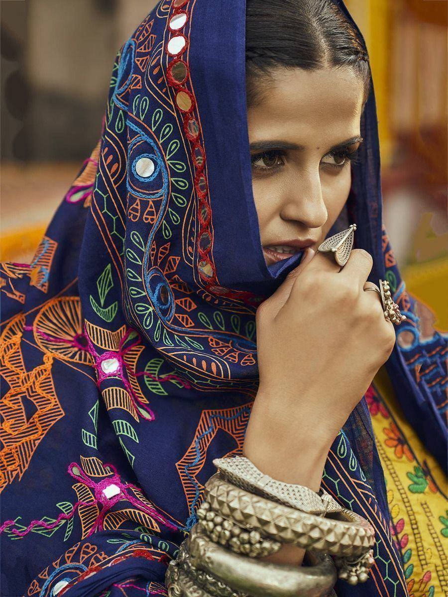 Woman in vibrant blue embroidered dupatta with mirror work, traditional Indian ethnic wear, statement silver jewelry