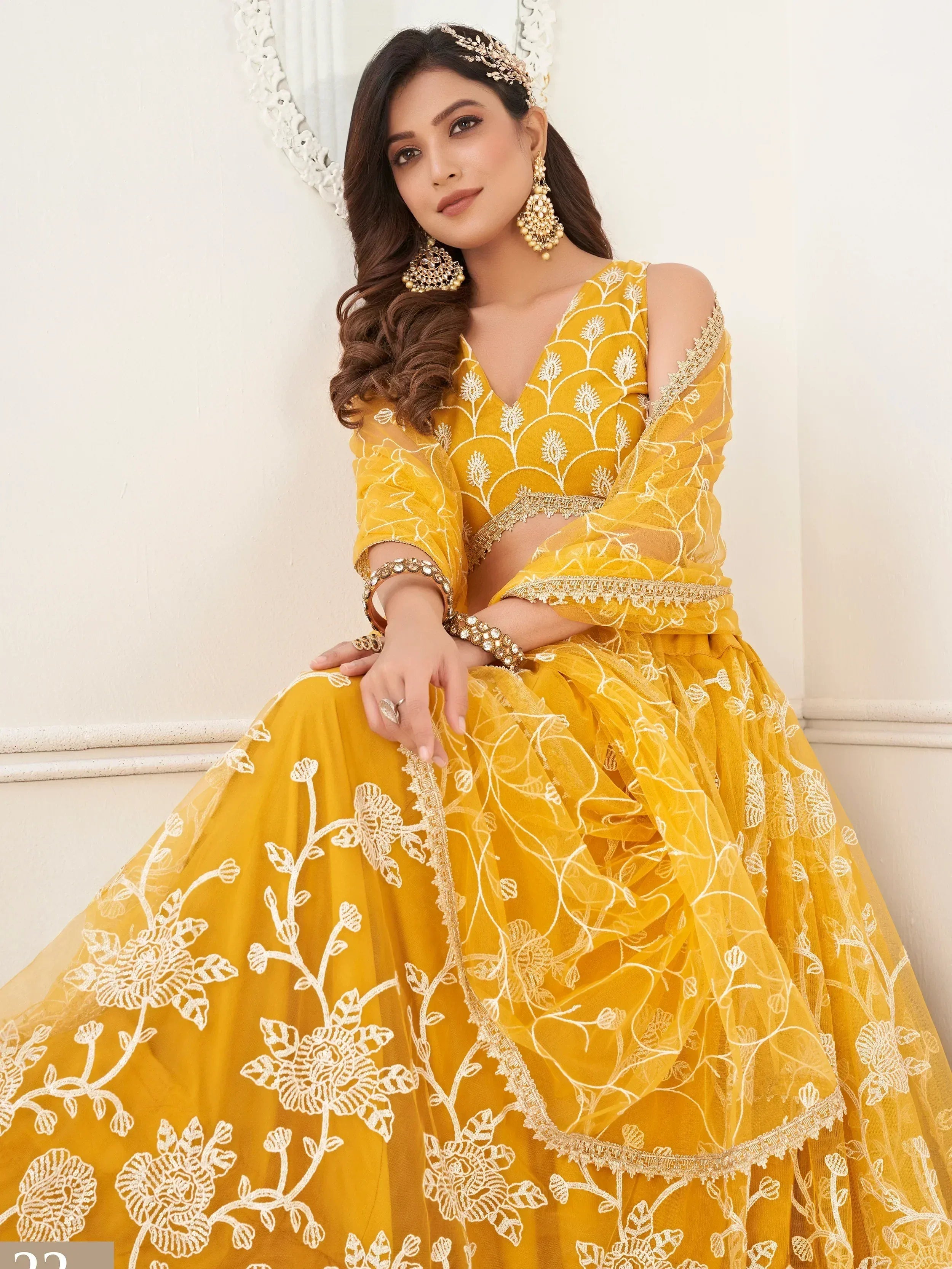 Yellow floral embroidered lehenga choli with cold shoulder blouse, perfect for Indian weddings and festive occasions