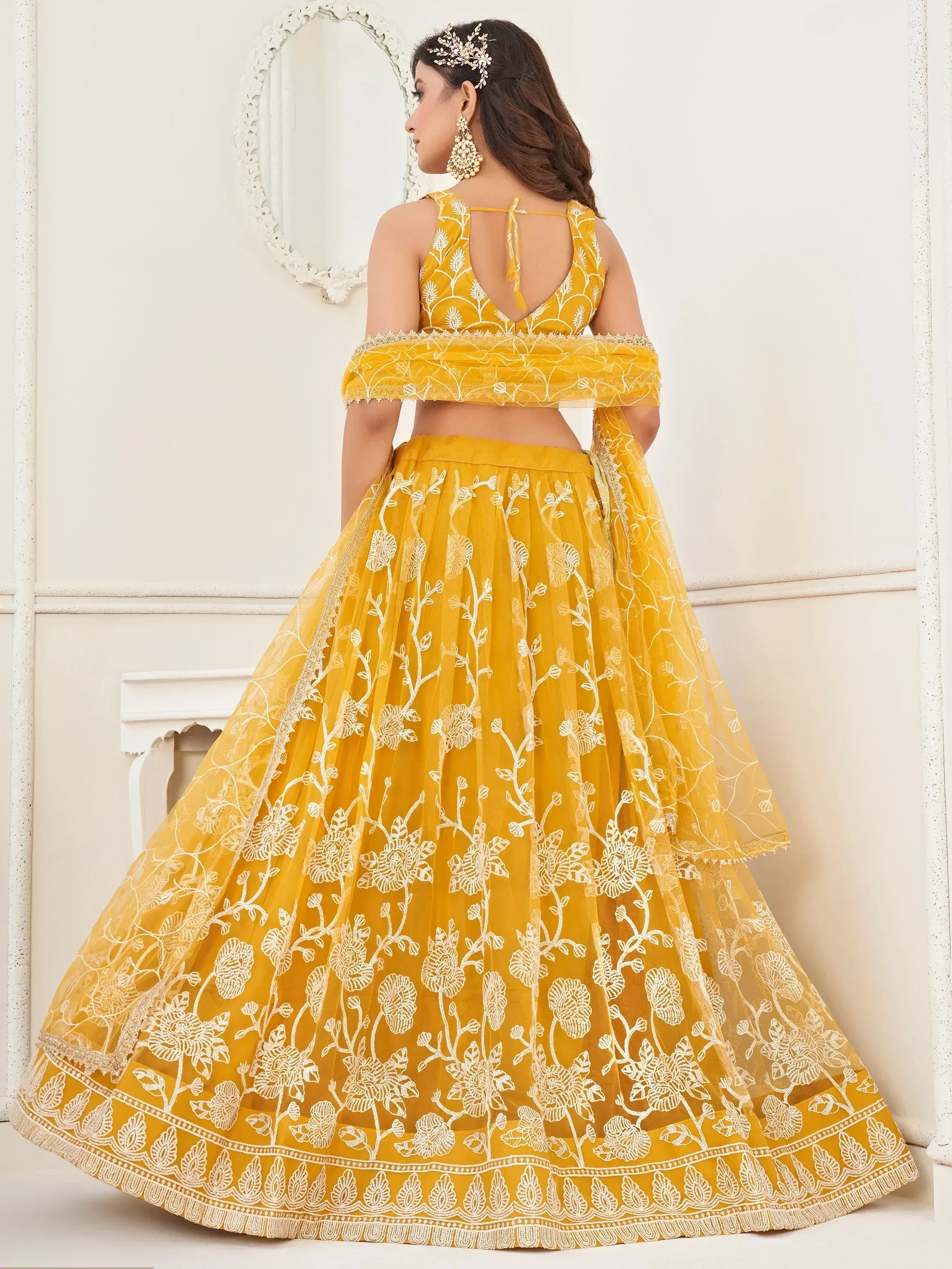 Yellow floral embroidered lehenga choli with off-shoulder dupatta, perfect for Indian ethnic wear occasions