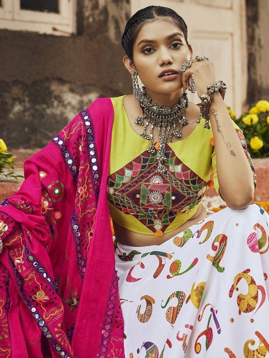 Vibrant Indian ethnic wear with embroidered crop top, printed skirt, and mirror-work dupatta
