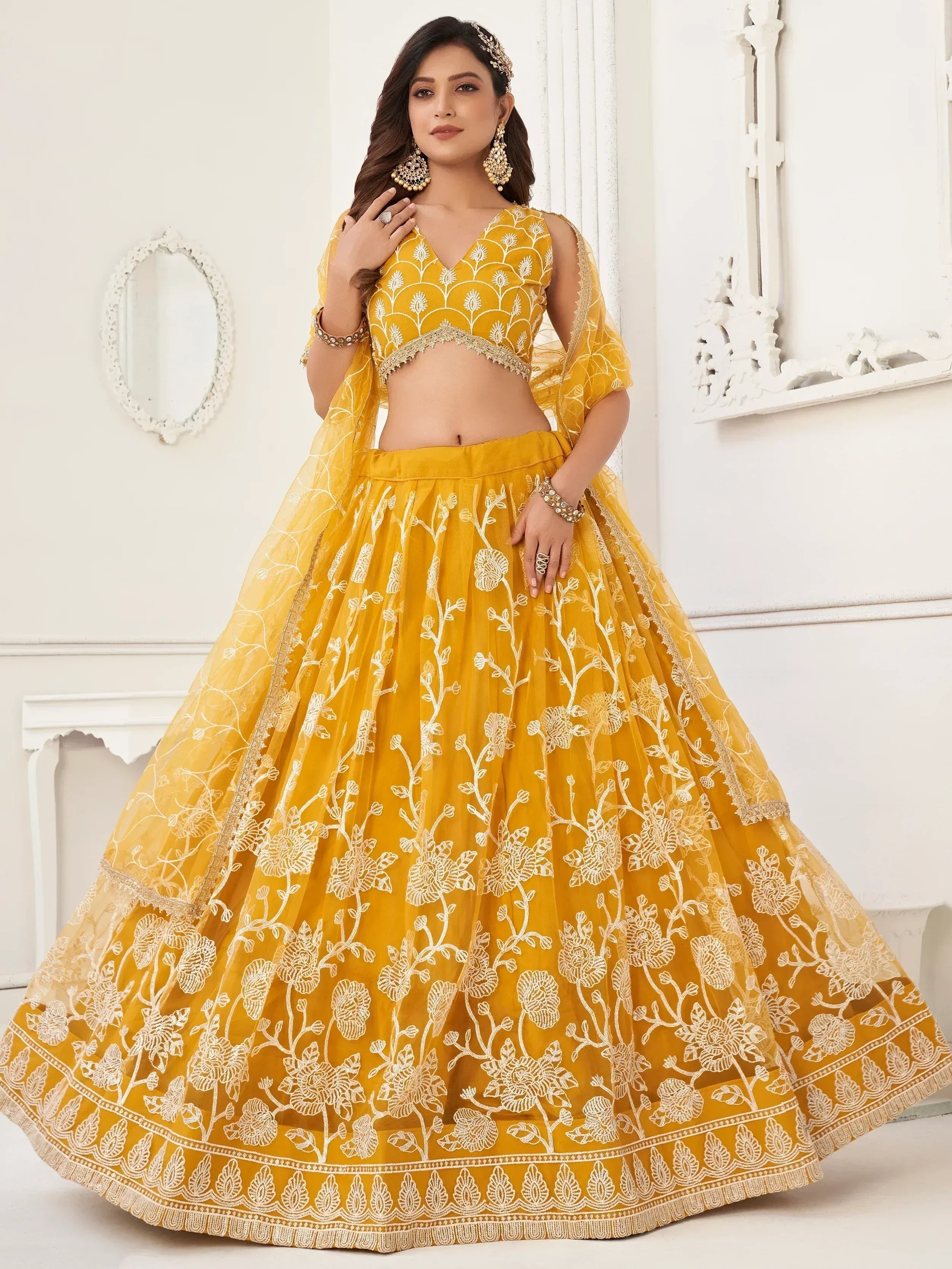 Yellow embroidered lehenga choli with floral design, perfect for Indian ethnic wear and weddings