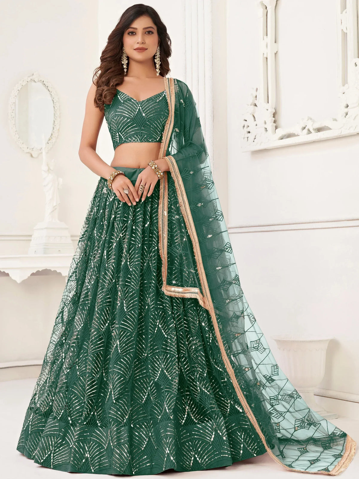 Emerald green designer lehenga choli with sequin work and sheer dupatta, perfect for weddings and parties.