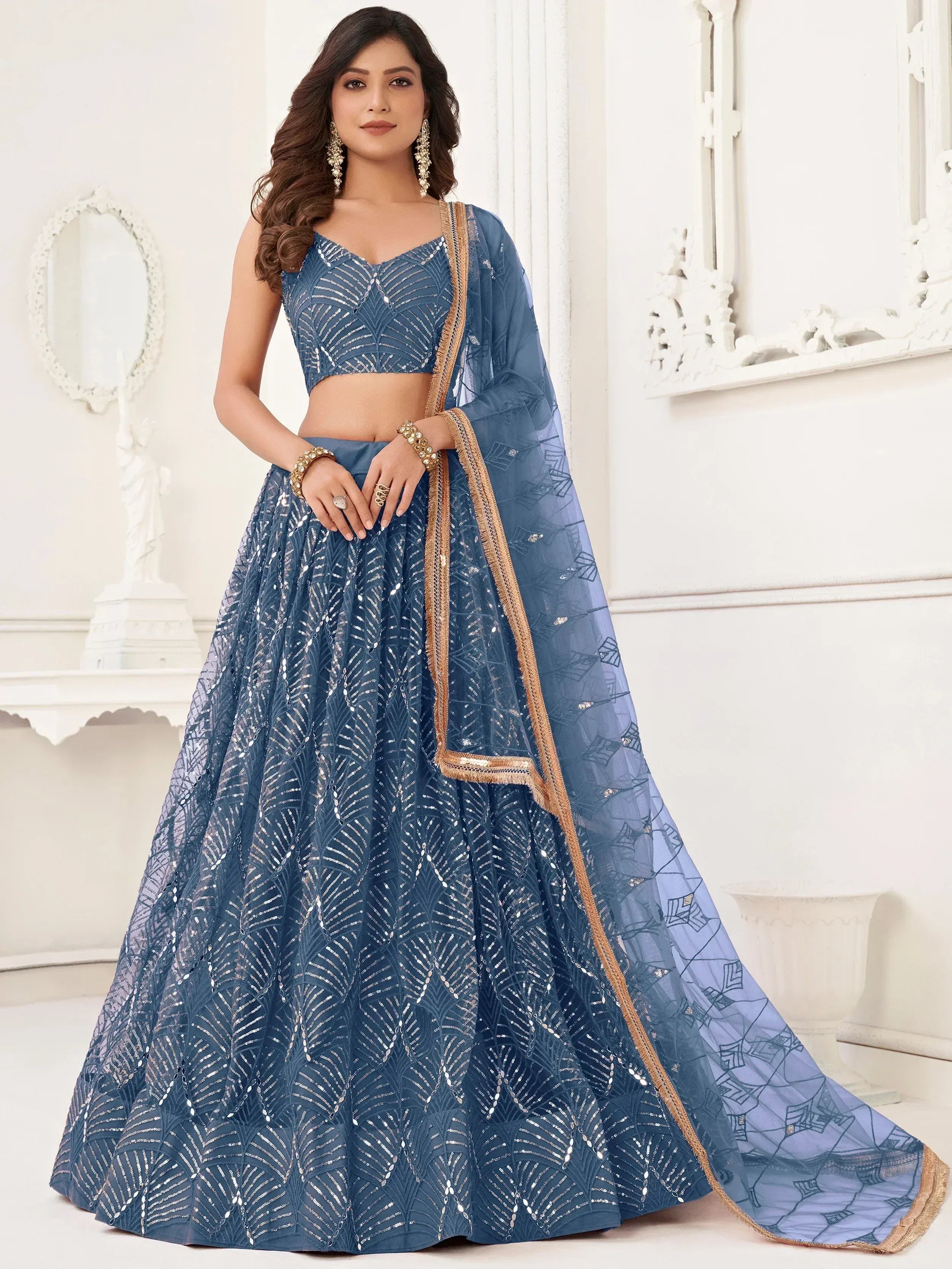 Blue designer lehenga choli with sequin work and gold trim, perfect for weddings and festive occasions
