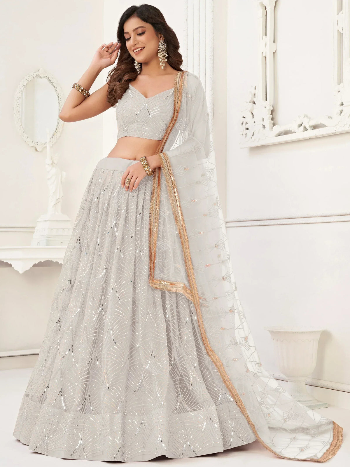 Elegant silver lehenga choli with sequin embroidery and gold trim, perfect for Indian ethnic occasions