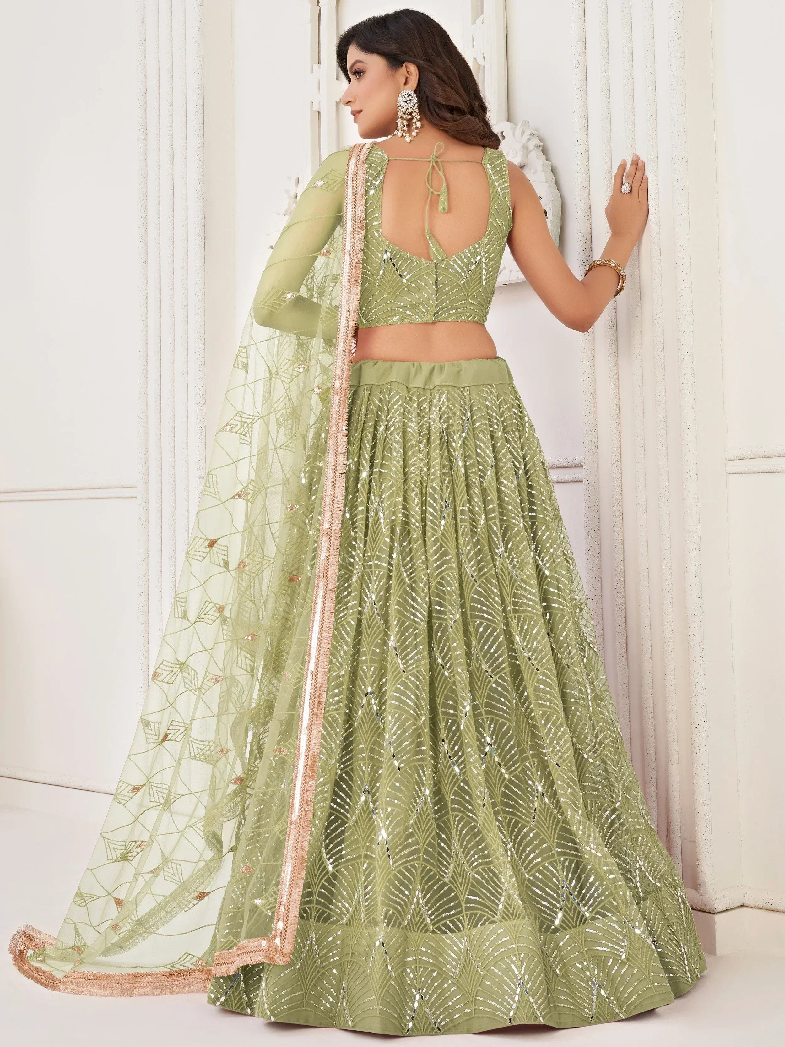Olive green designer lehenga choli with sequin work and sheer dupatta, perfect for Indian ethnic occasions.