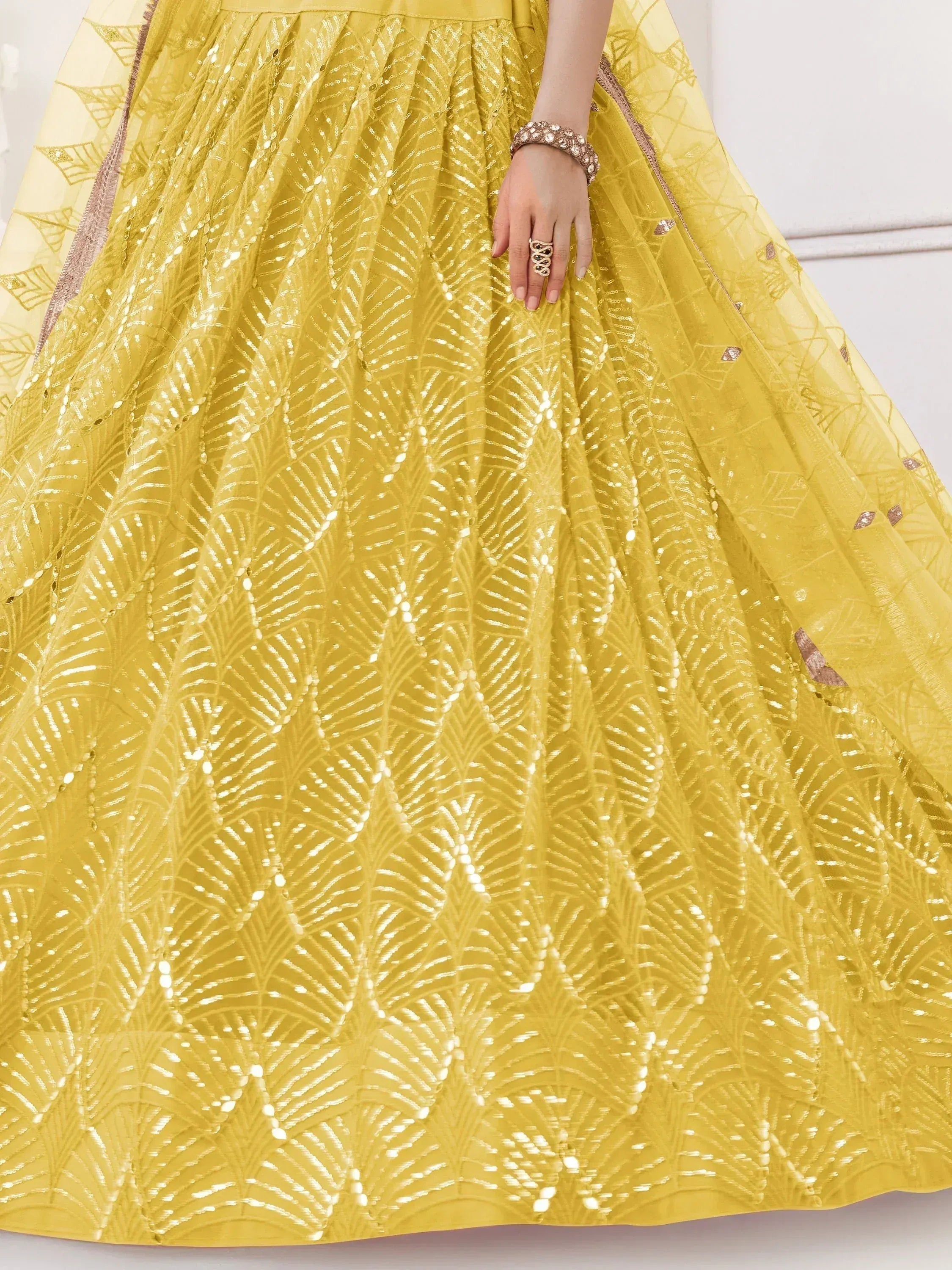 Yellow designer lehenga with sequin leaf pattern, perfect for Indian ethnic wear events