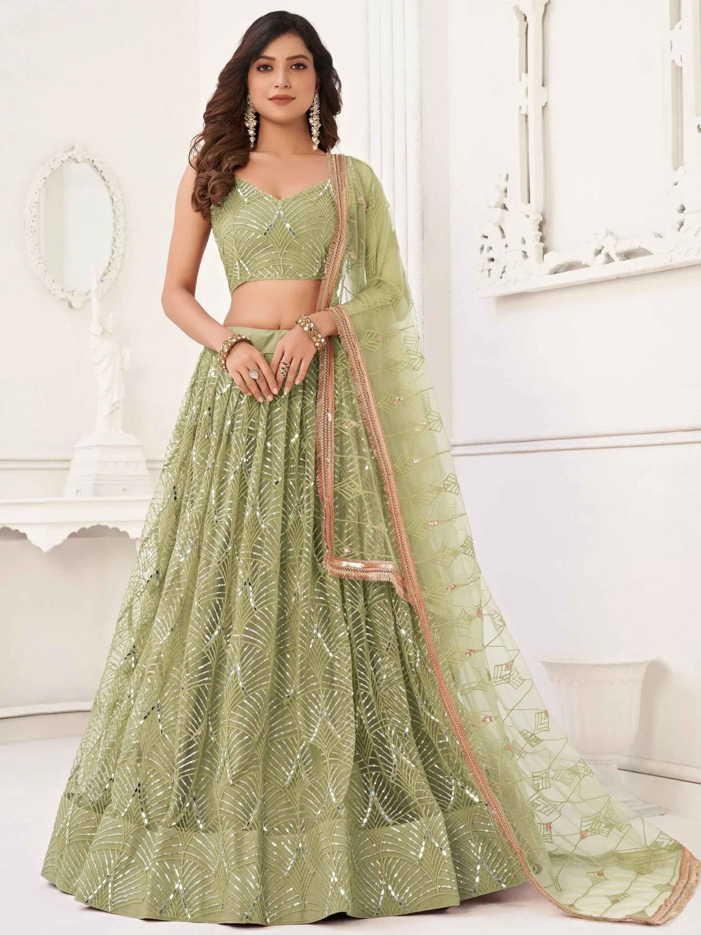 Mint green designer lehenga choli with sequin embroidery and gold trim, perfect for weddings and festive occasions.