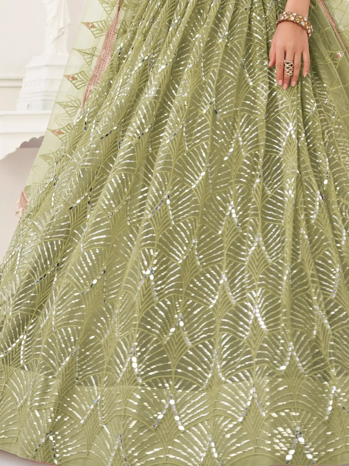 Olive green lehenga with intricate silver leaf embroidery and sequin detailing