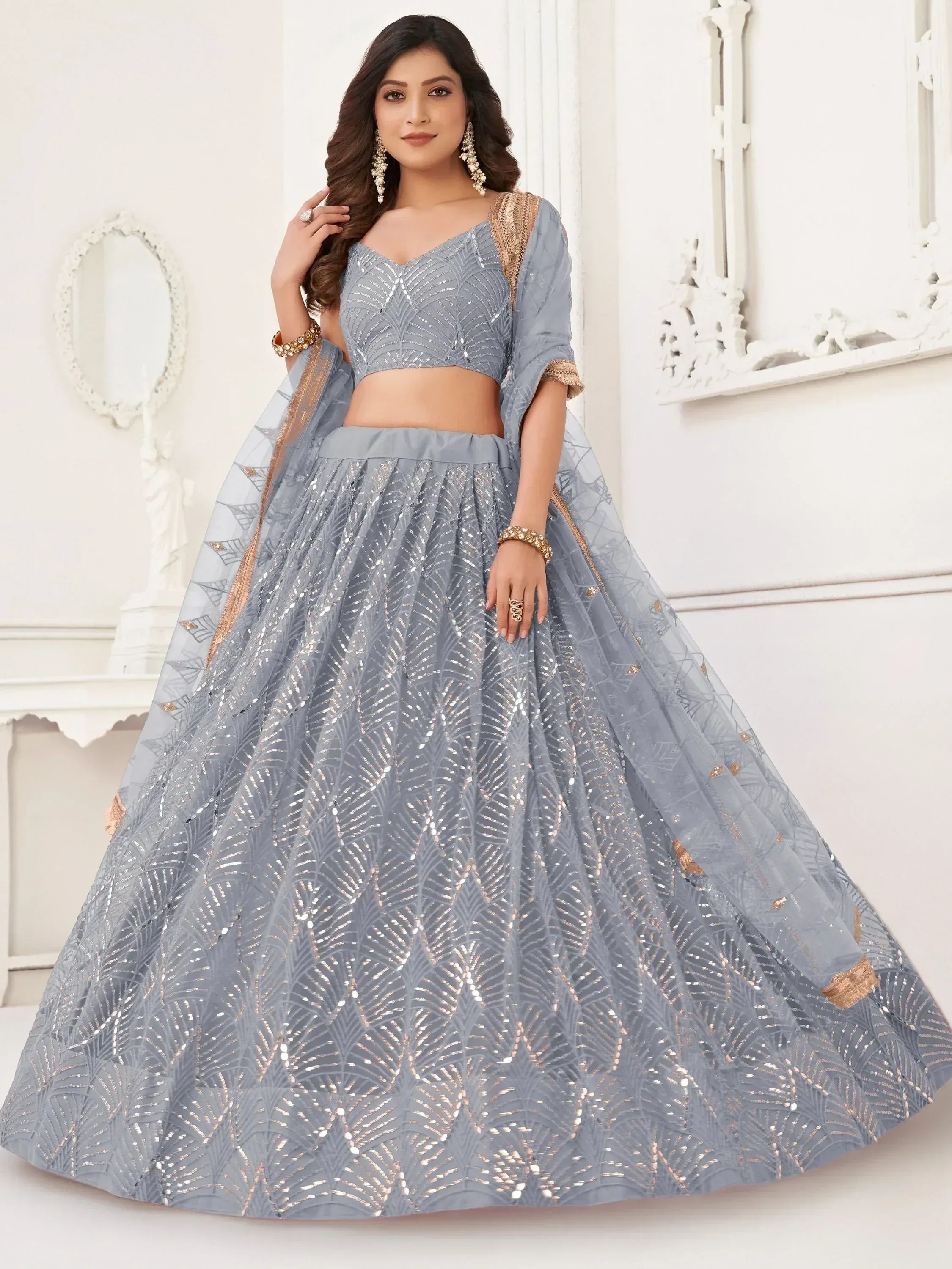 Elegant grey lehenga choli with sequin embroidery and gold accents for festive occasions