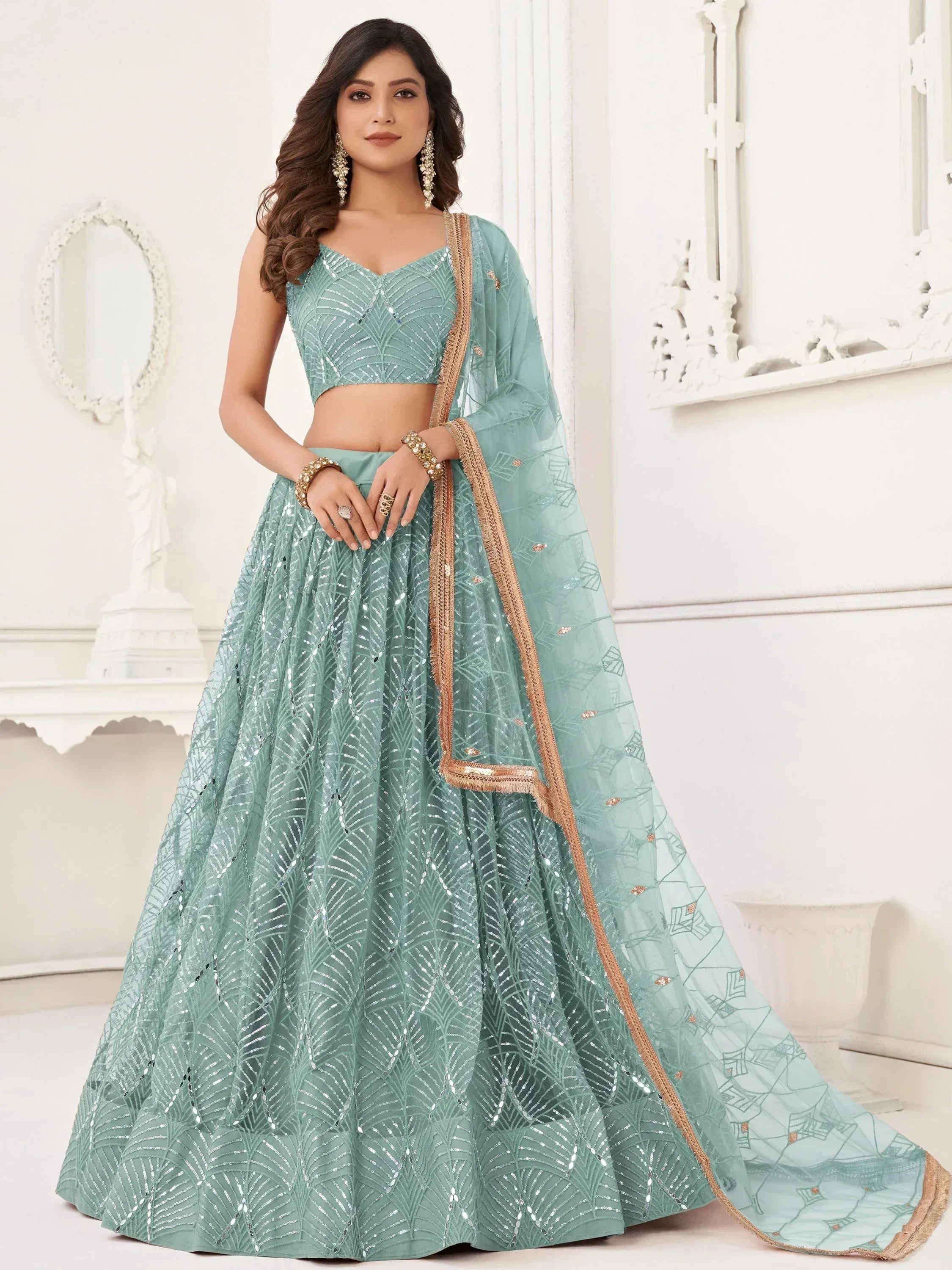 Mint green designer lehenga choli with sequin work and gold border, perfect for Indian weddings and parties