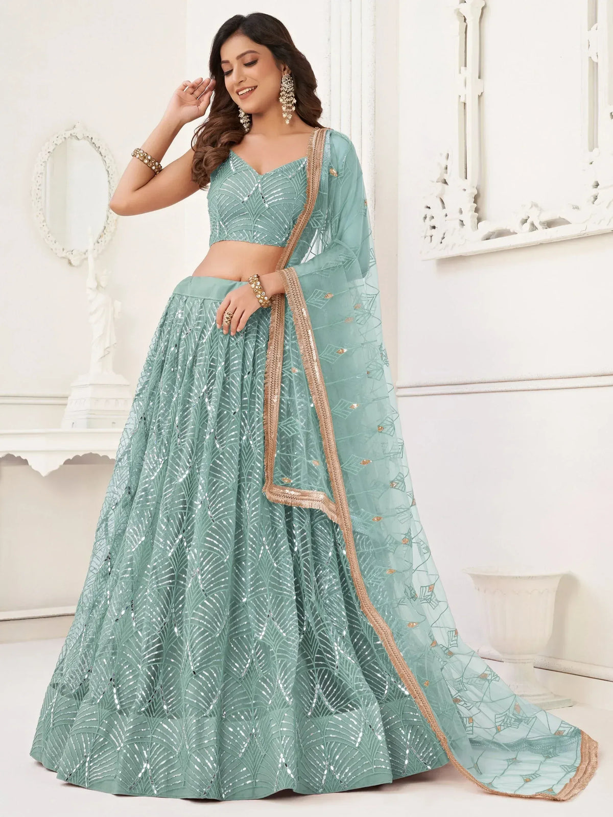 Mint green designer lehenga choli with sequin work and gold border, perfect for Indian ethnic occasions