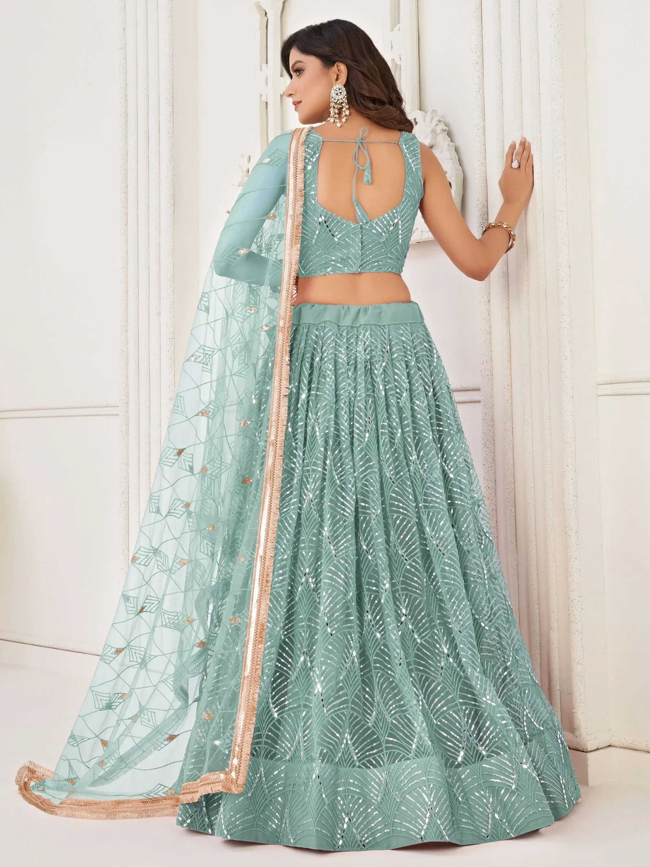 Mint green sequin lehenga choli with sheer dupatta, perfect for Indian weddings and festive occasions.