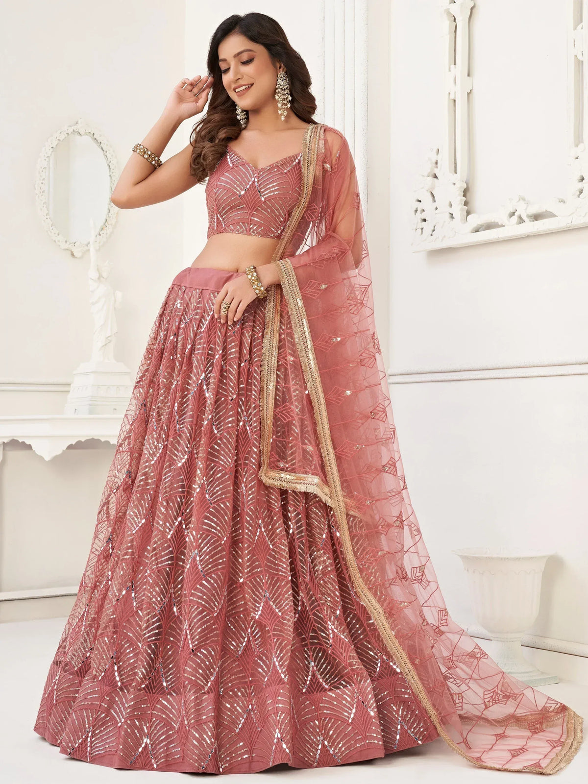 Pink designer lehenga choli with sequin work and gold trim, perfect for Indian weddings and festive occasions
