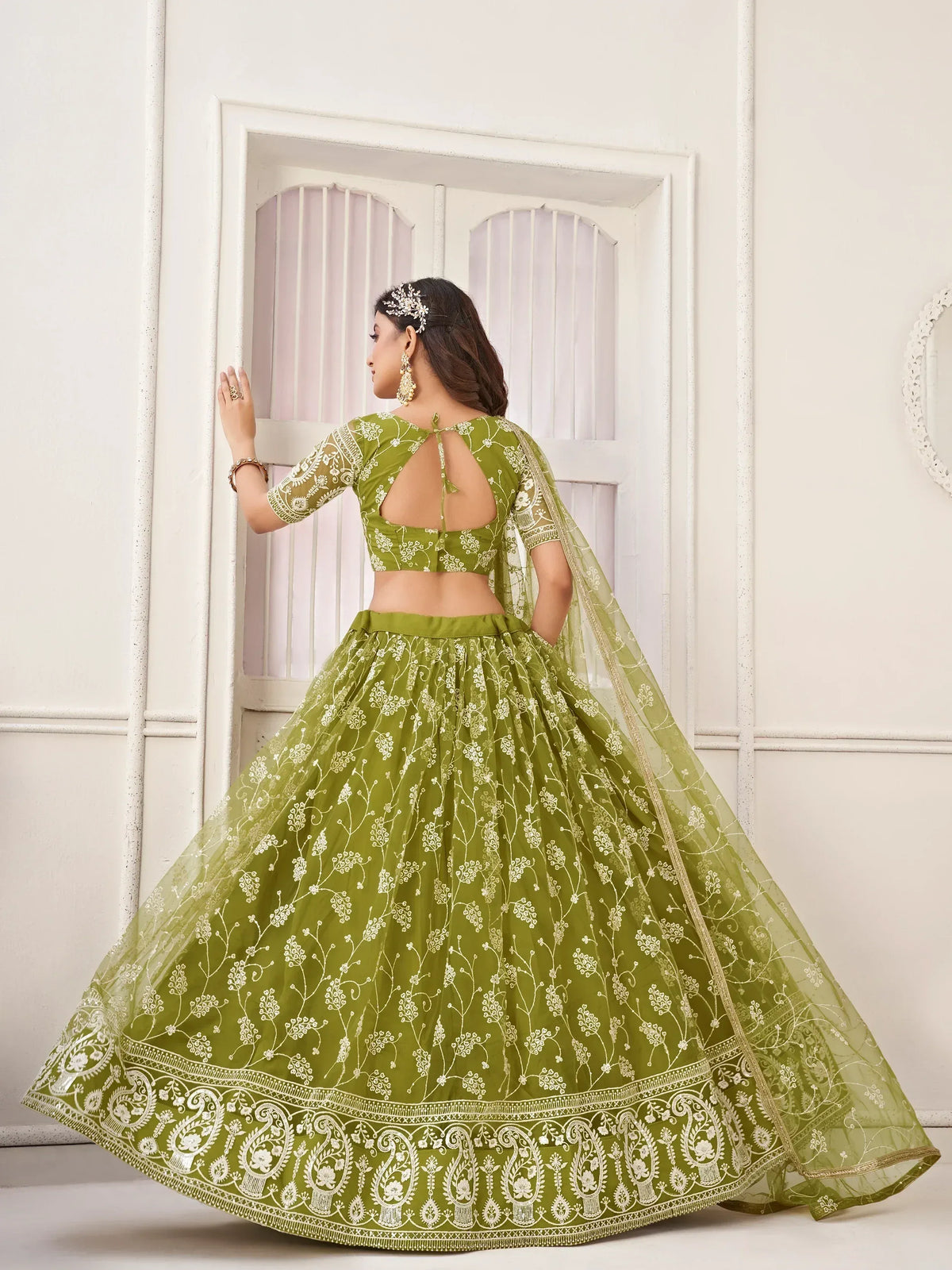 Olive green embroidered lehenga choli with floral motifs and sheer dupatta, perfect for Indian ethnic wear occasions.