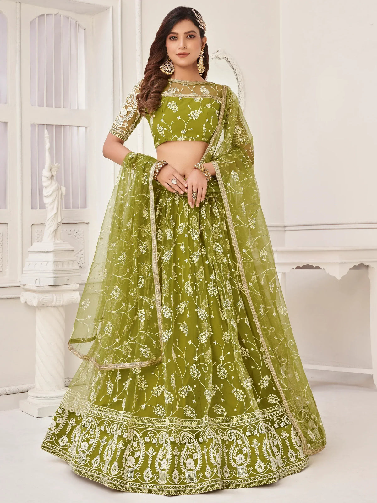 Green embroidered lehenga choli with floral designs and gold trim, perfect for Indian ethnic wear.