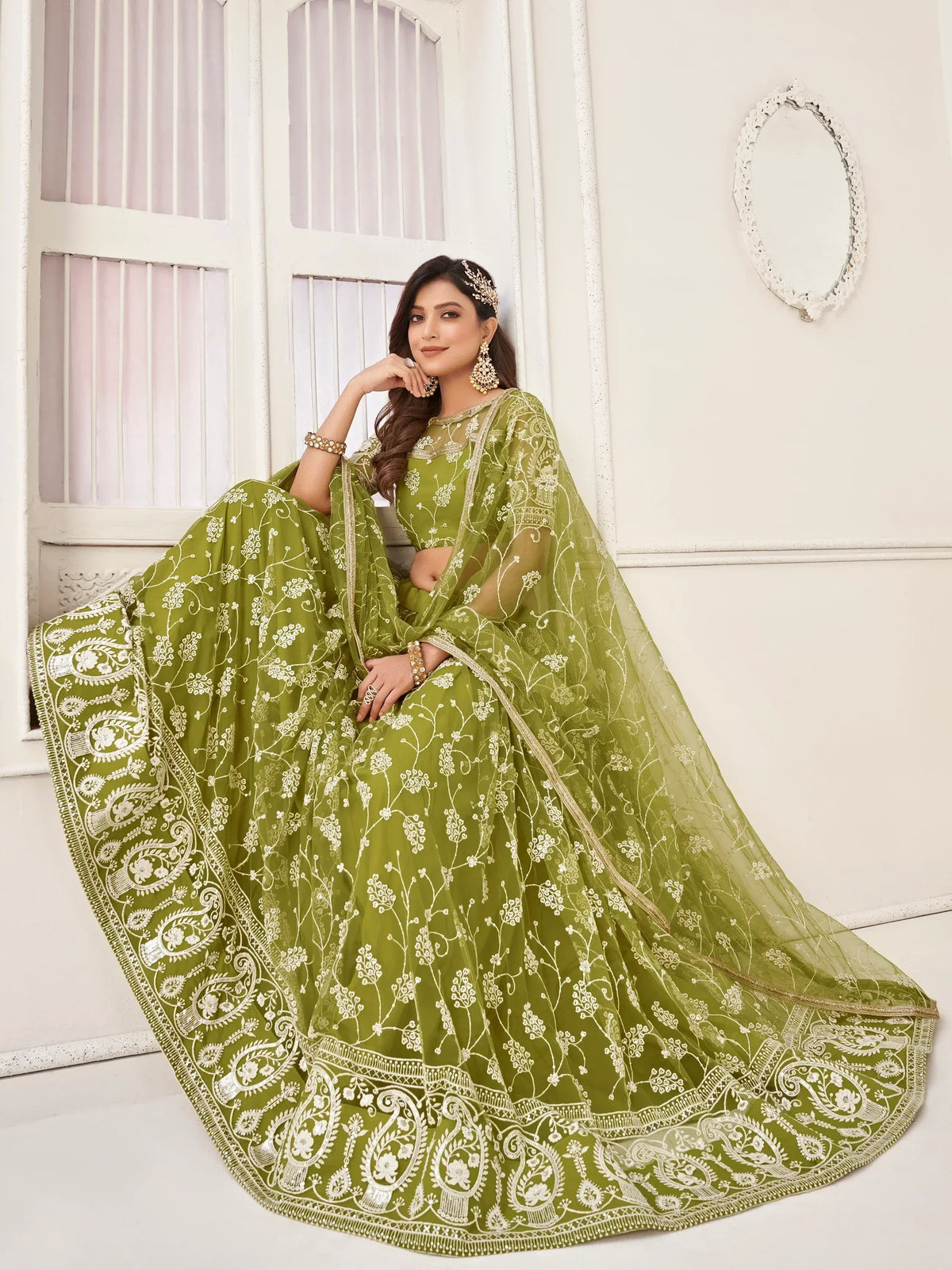 Olive green embroidered lehenga choli with floral motifs and sheer dupatta, perfect for Indian ethnic occasions.