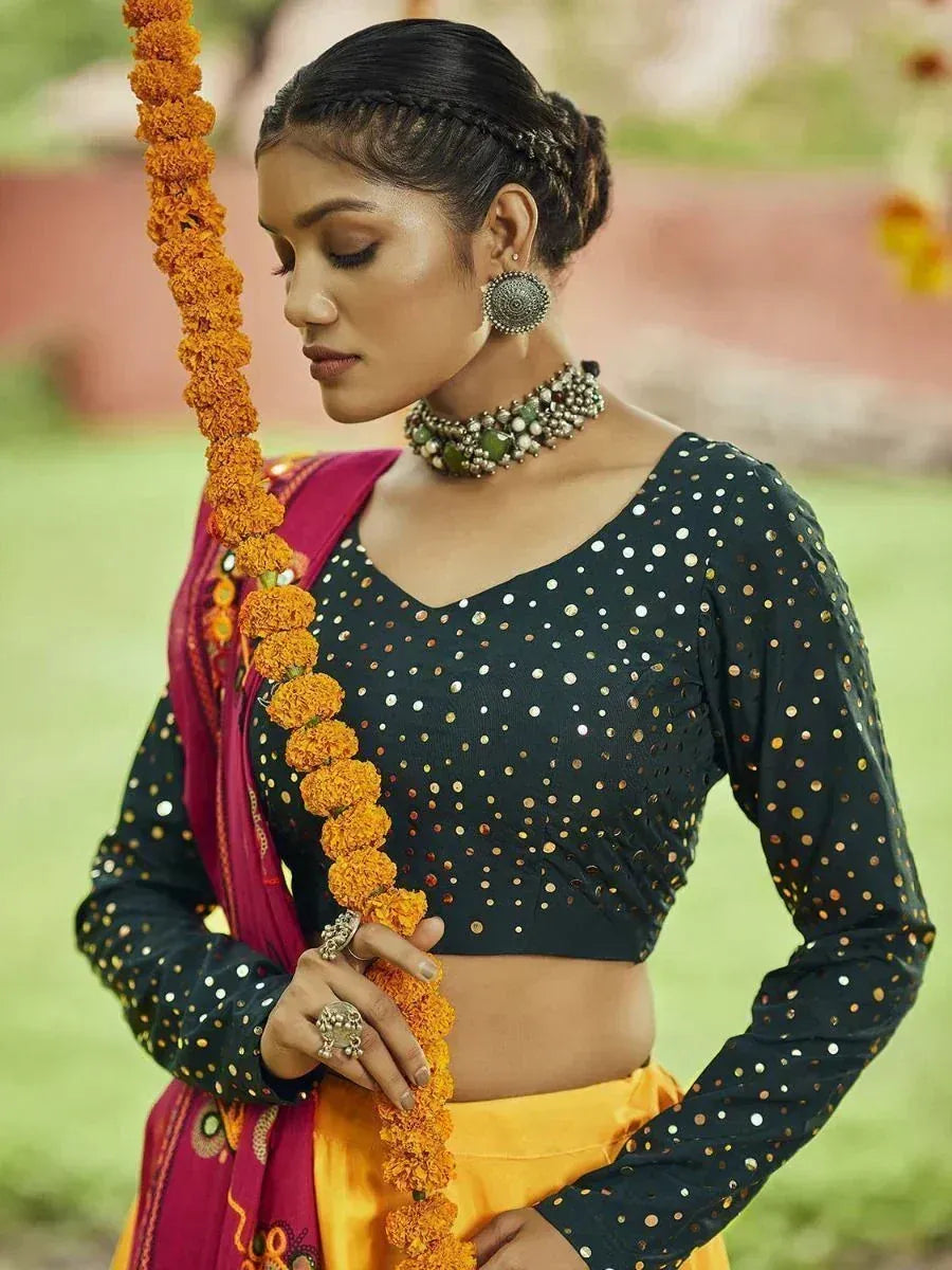 Black sequin blouse with yellow skirt, marigold garland, ethnic Indian wear
