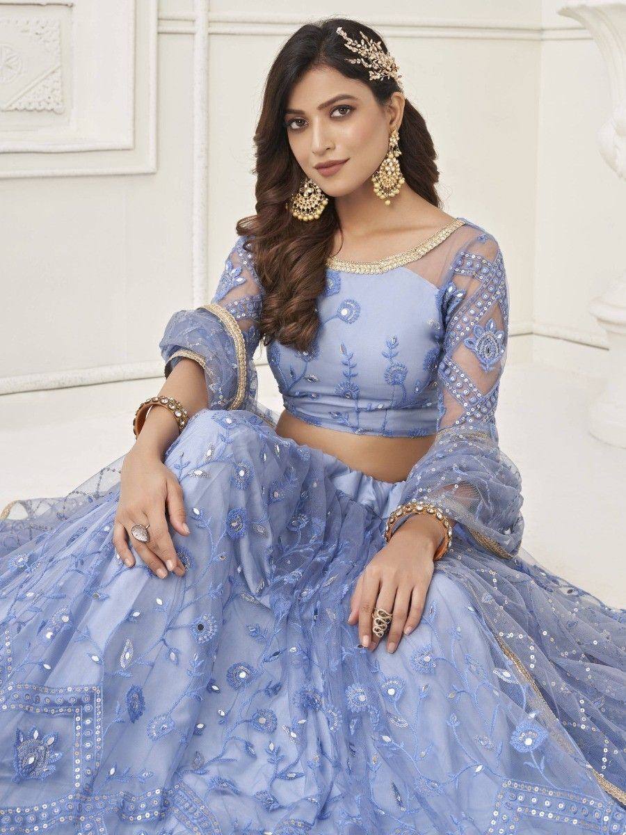 Light blue embroidered lehenga choli with sheer sleeves and gold jewelry, perfect for Indian ethnic occasions