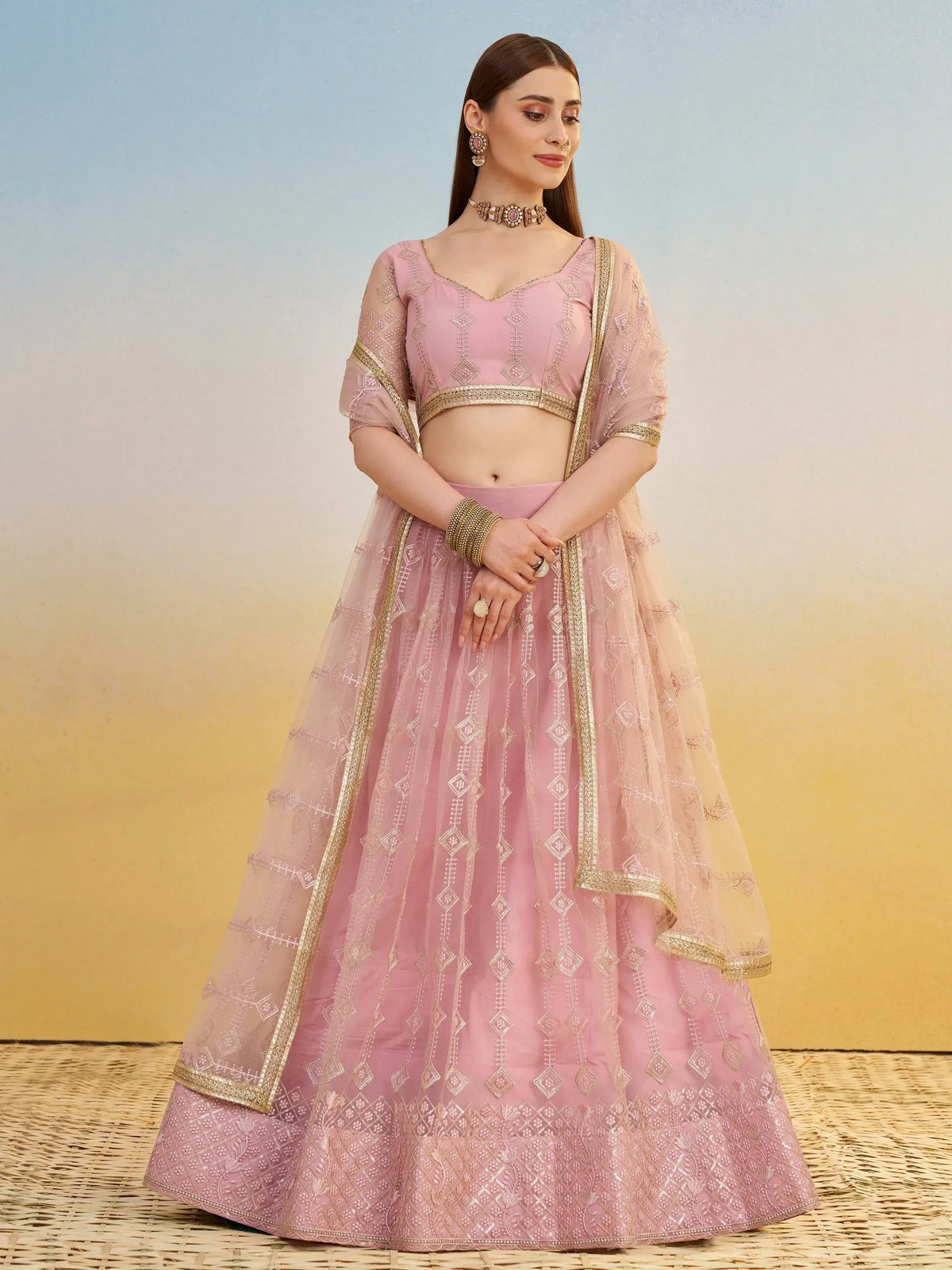 Pink embroidered lehenga choli with gold detailing, perfect for Indian ethnic wear and festive occasions