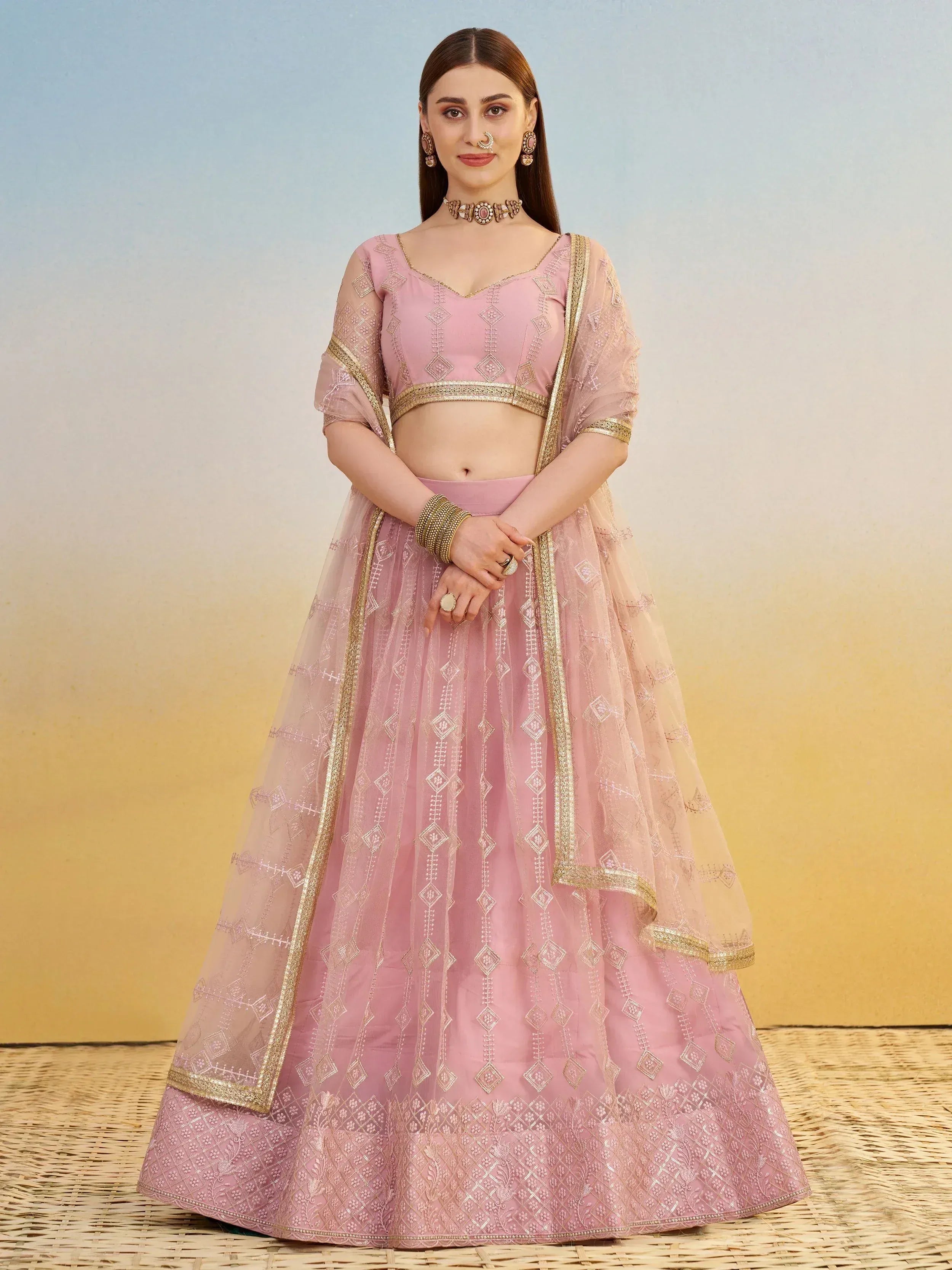 Pink designer lehenga choli with gold embroidery and sheer dupatta, perfect for Indian ethnic wear