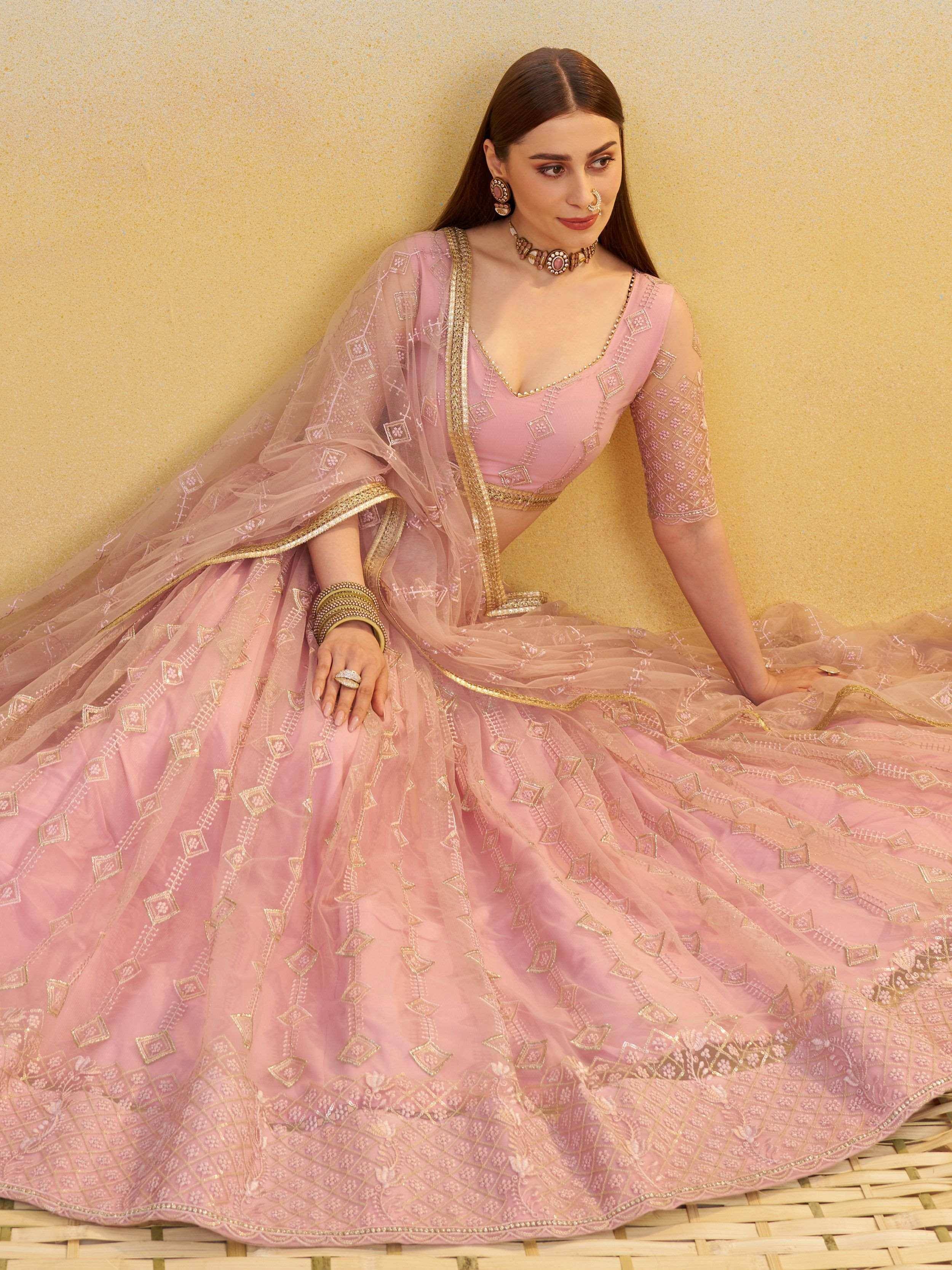 Pink embroidered lehenga choli with gold detailing, perfect for Indian ethnic wear and festive occasions.