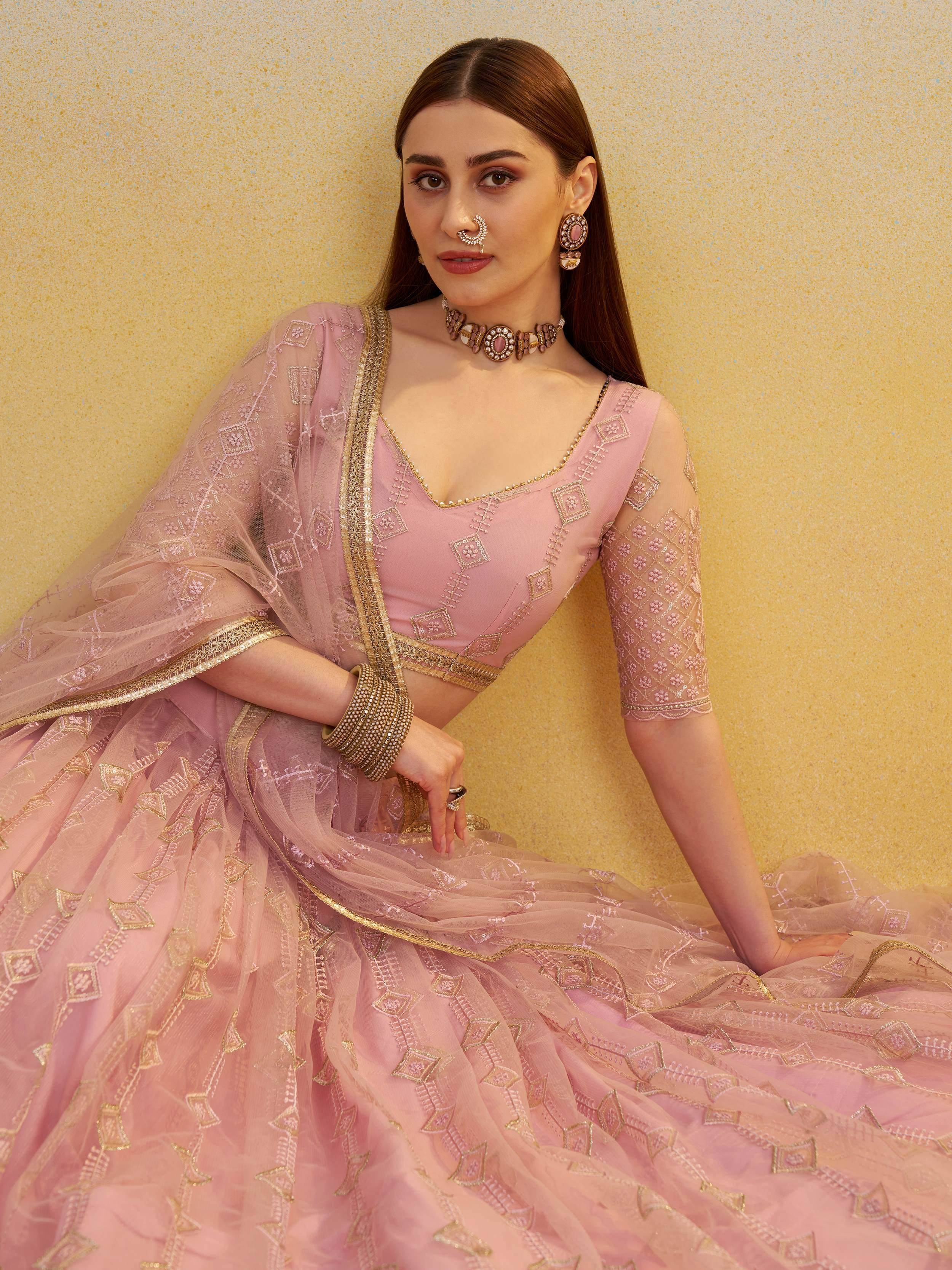 Pink embroidered lehenga choli with gold detailing, perfect for Indian ethnic wear and festive occasions