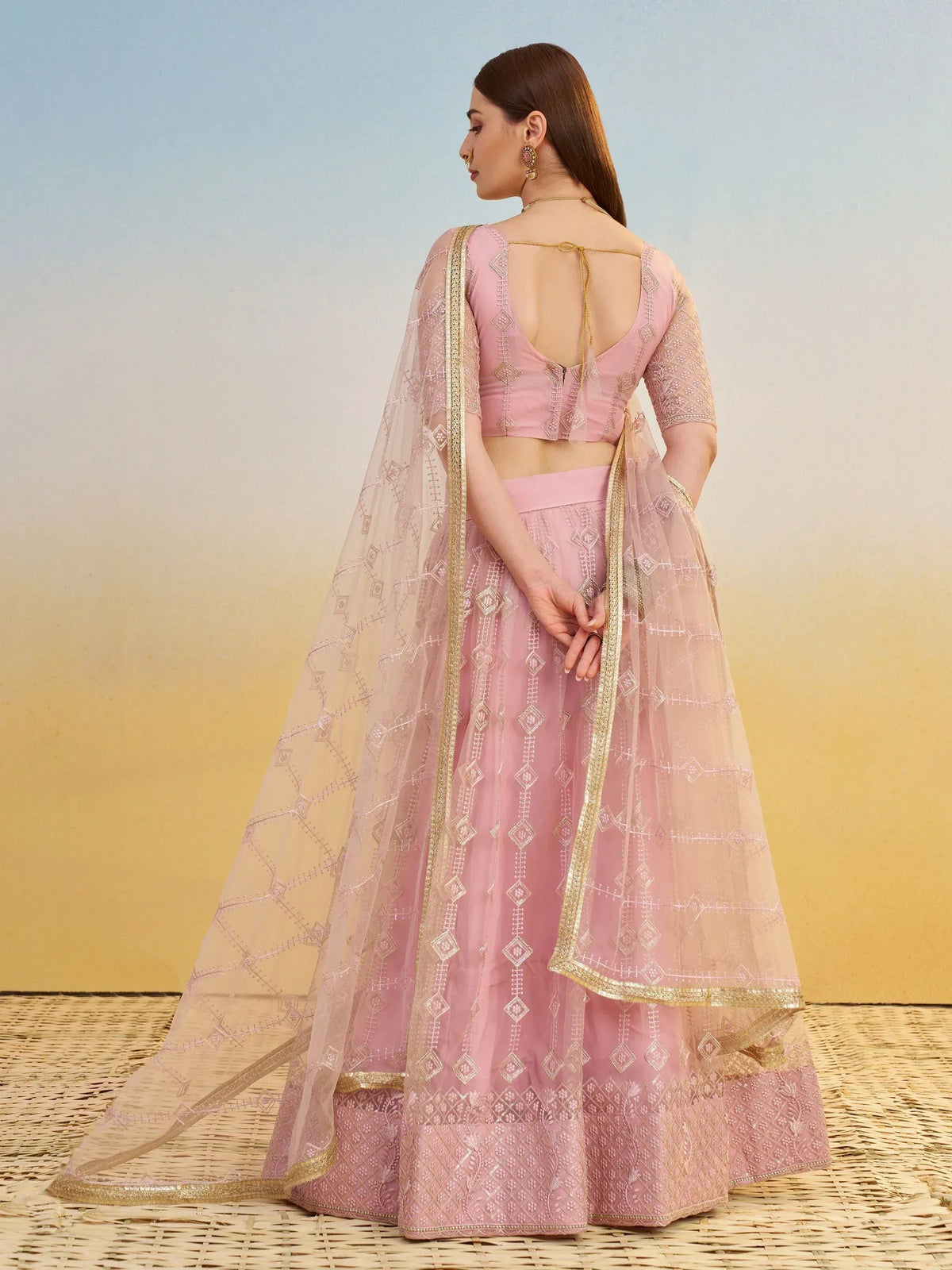 Pink designer lehenga choli with gold embroidery and sheer dupatta, ethnic Indian wear