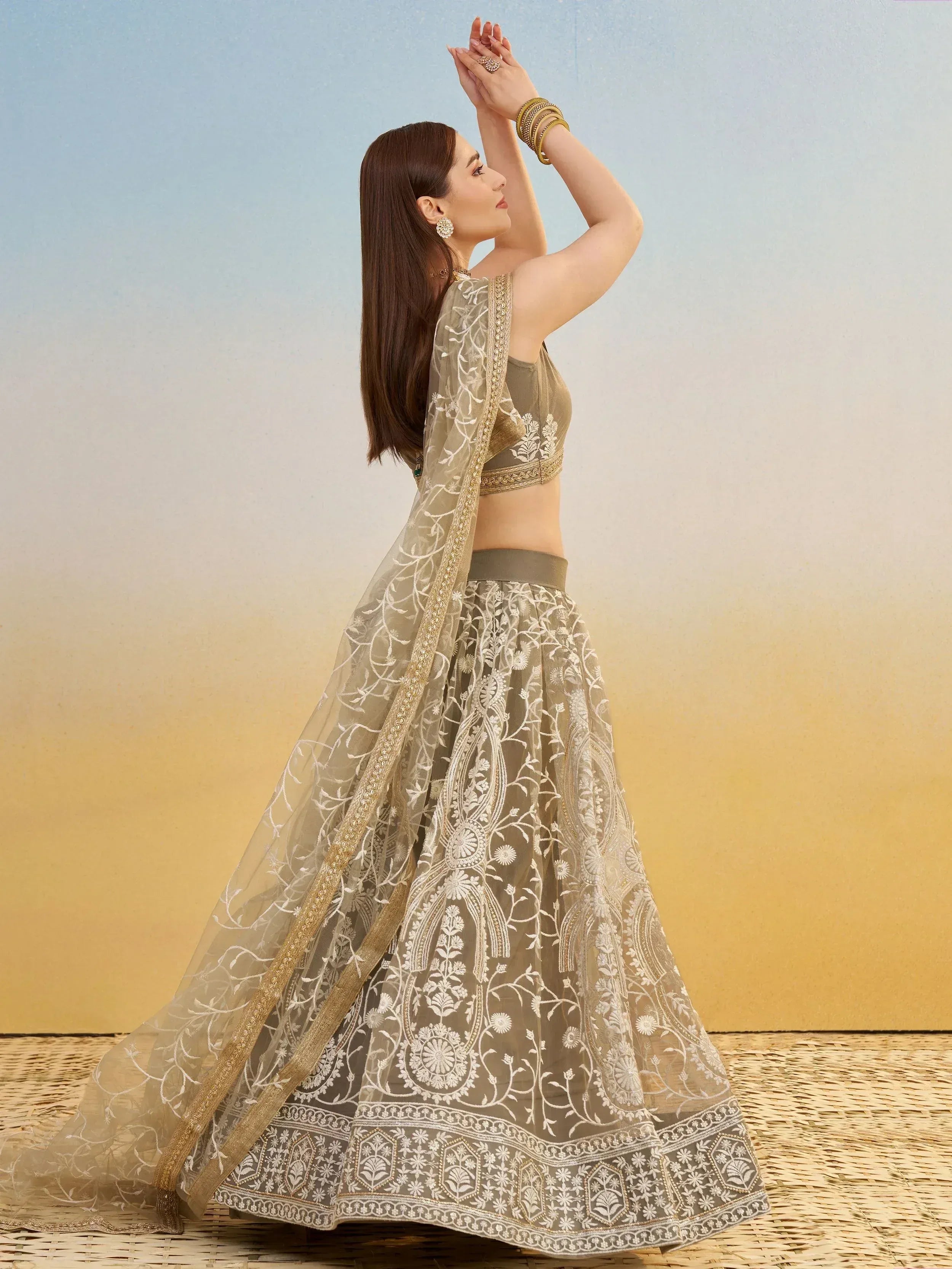 Elegant olive green lehenga choli with white floral embroidery and gold trim, perfect for Indian ethnic wear.