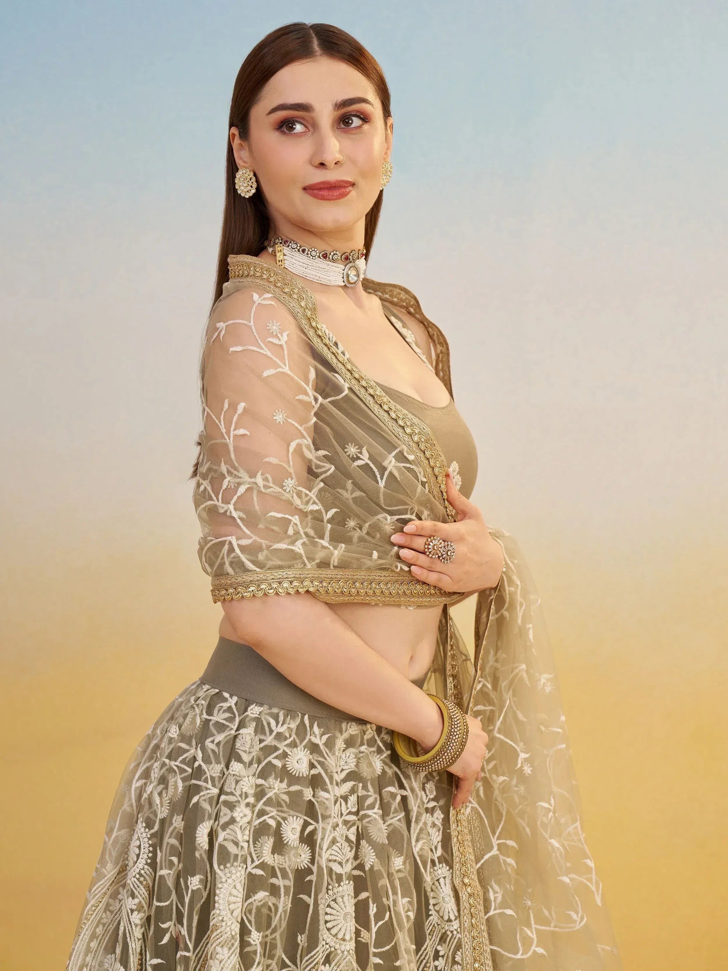 Elegant olive green lehenga choli with white floral embroidery and gold trim, perfect for Indian ethnic wear.