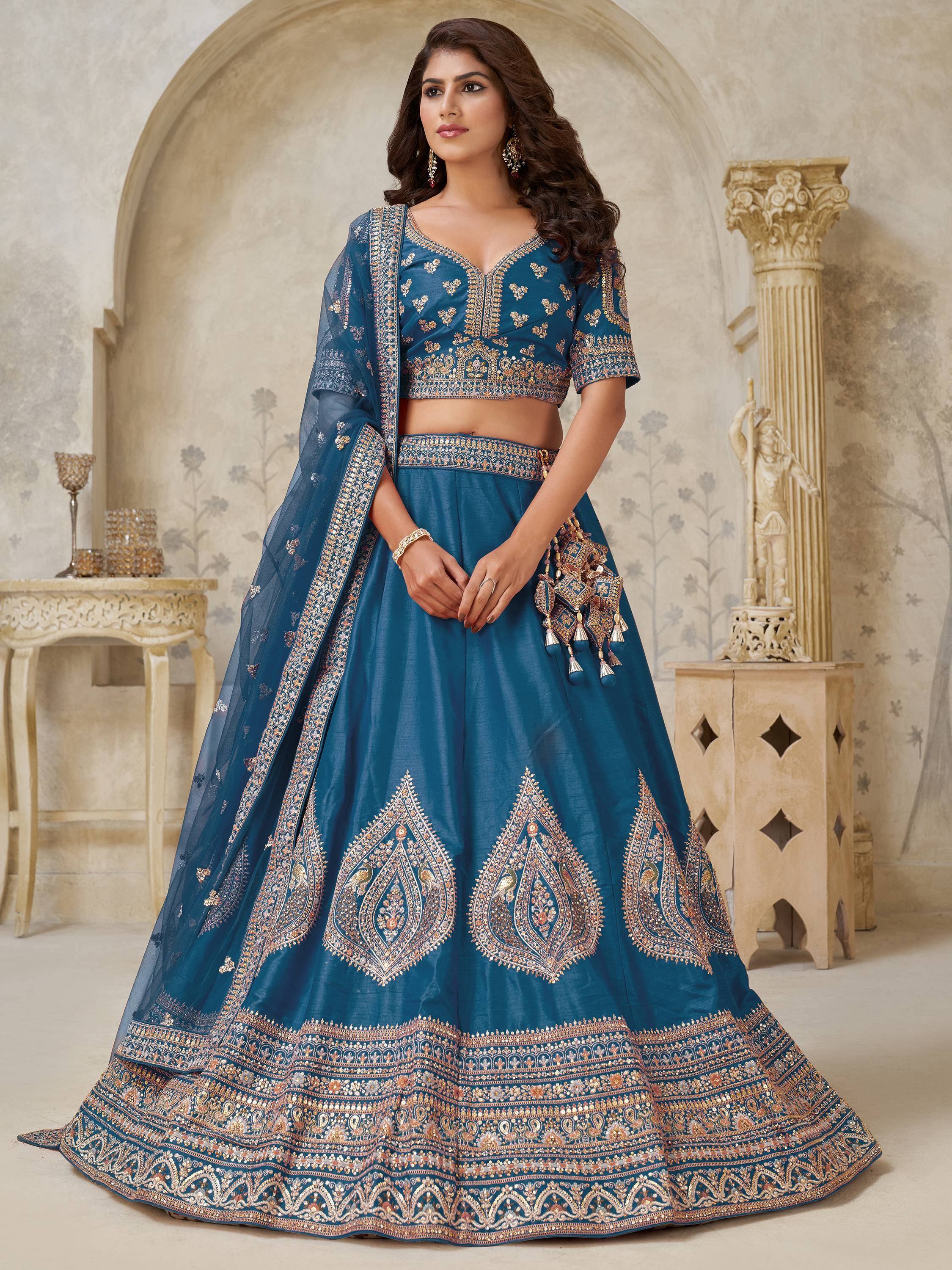 Teal blue embroidered lehenga choli with gold detailing, perfect for Indian weddings and festive occasions.