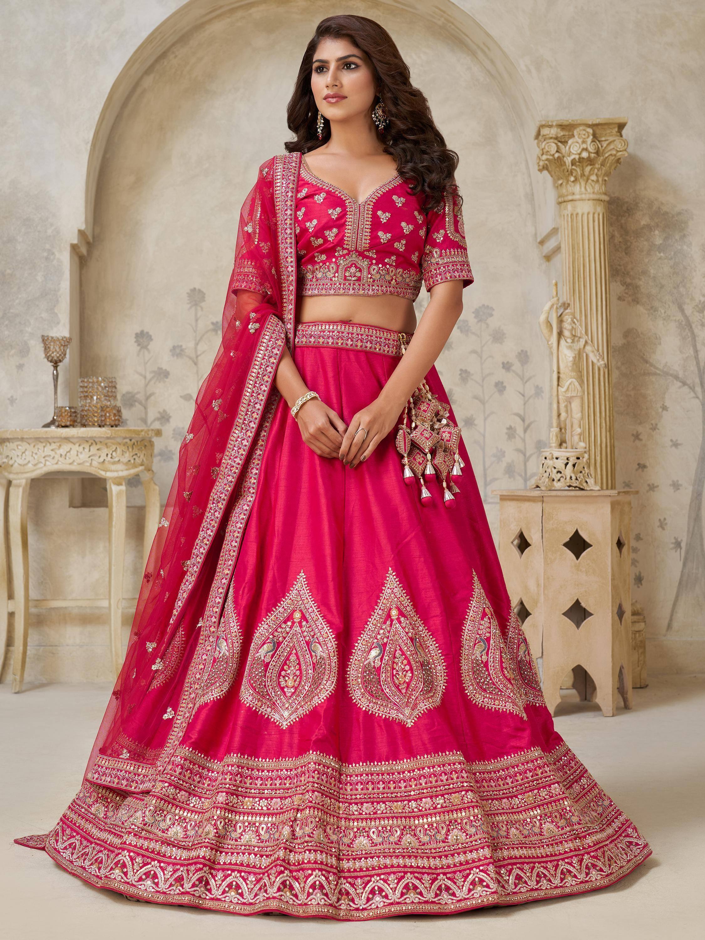 Fuchsia pink designer lehenga choli with gold embroidery, perfect for weddings and festive occasions.