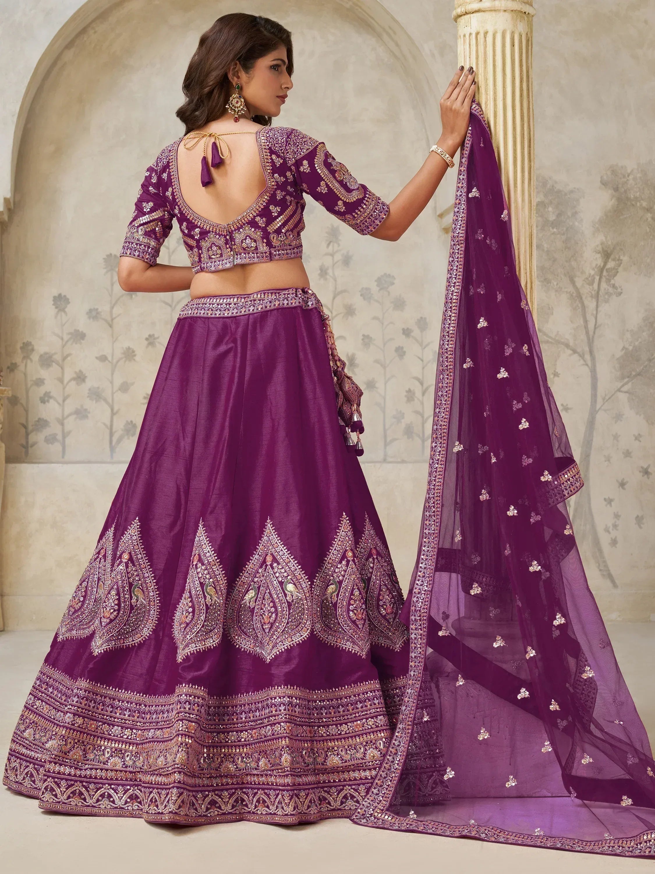 Purple embroidered lehenga choli with peacock motifs and sheer dupatta, ideal for Indian ethnic wear occasions.