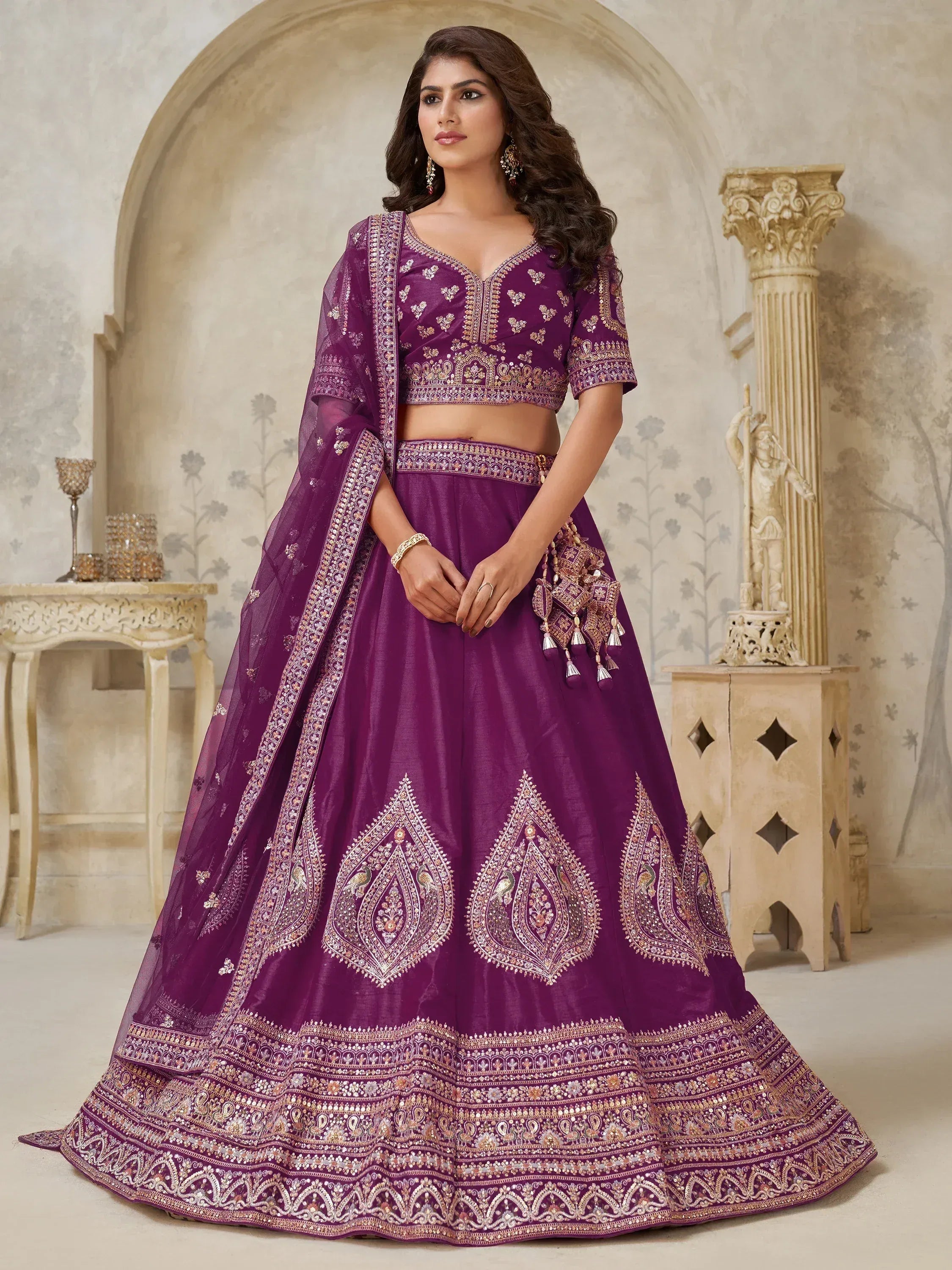 Elegant purple lehenga choli with intricate gold embroidery and embellished dupatta for Indian ethnic wear