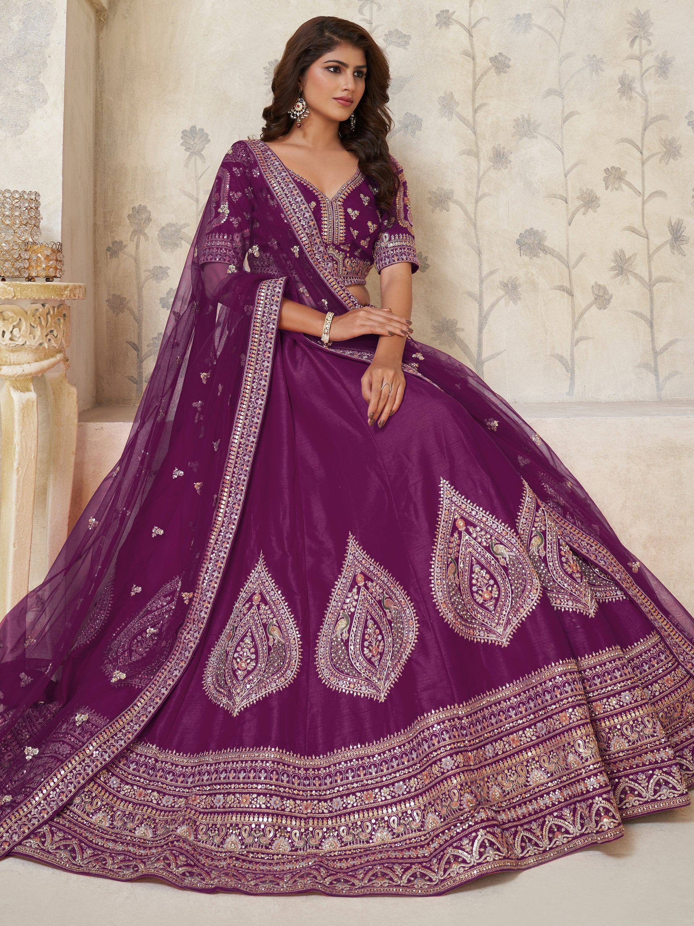 Purple embroidered lehenga choli with heavy gold work, perfect for Indian weddings and festive occasions.
