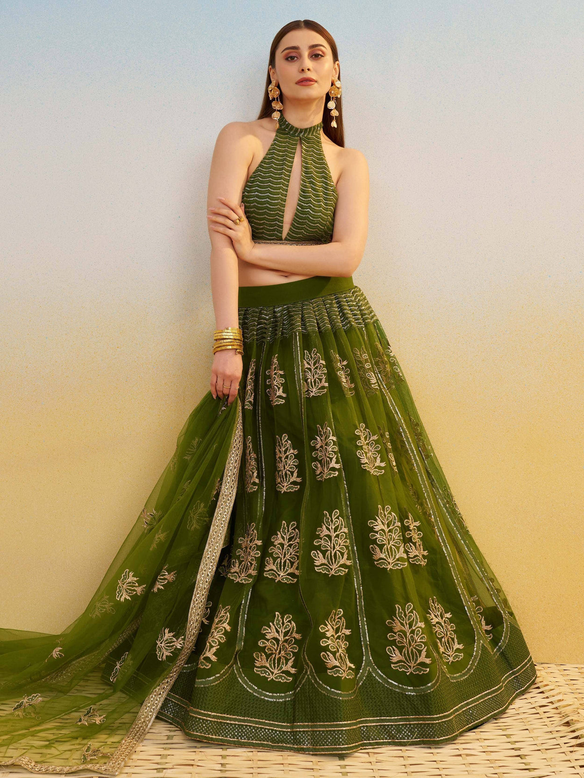 Green embroidered lehenga choli with halter neck blouse, perfect for Indian ethnic wear events