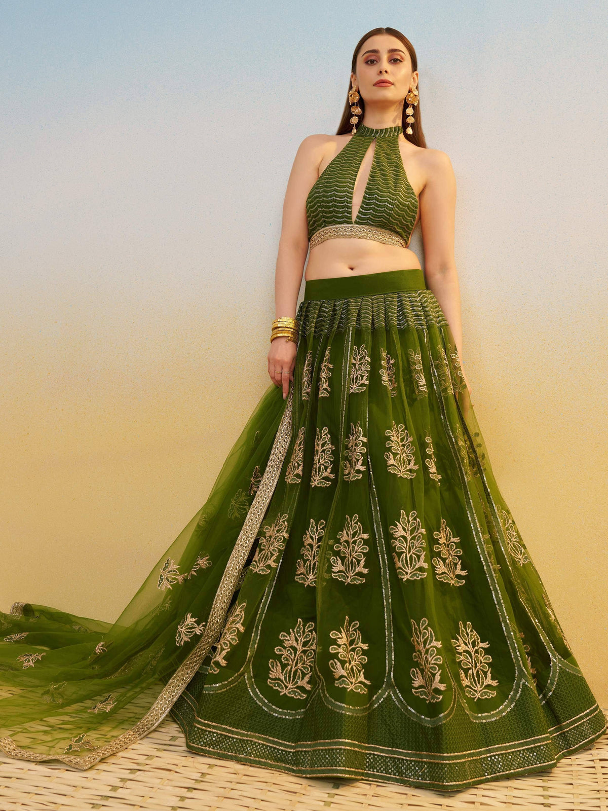 Green embroidered lehenga choli with gold detailing, halter neck blouse, ethnic wear for women
