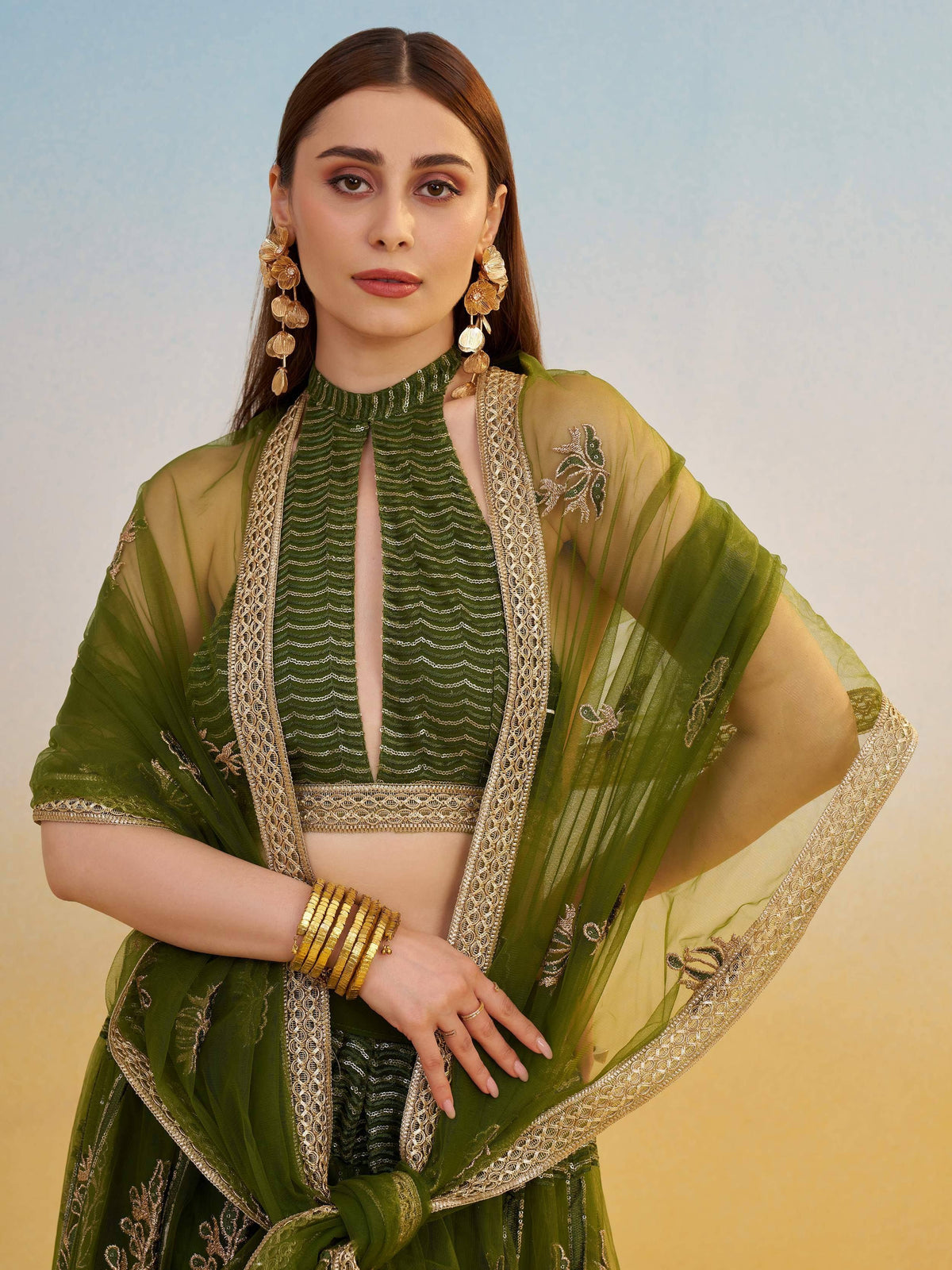 Green embroidered lehenga choli with gold detailing and sheer dupatta, Indian ethnic wear
