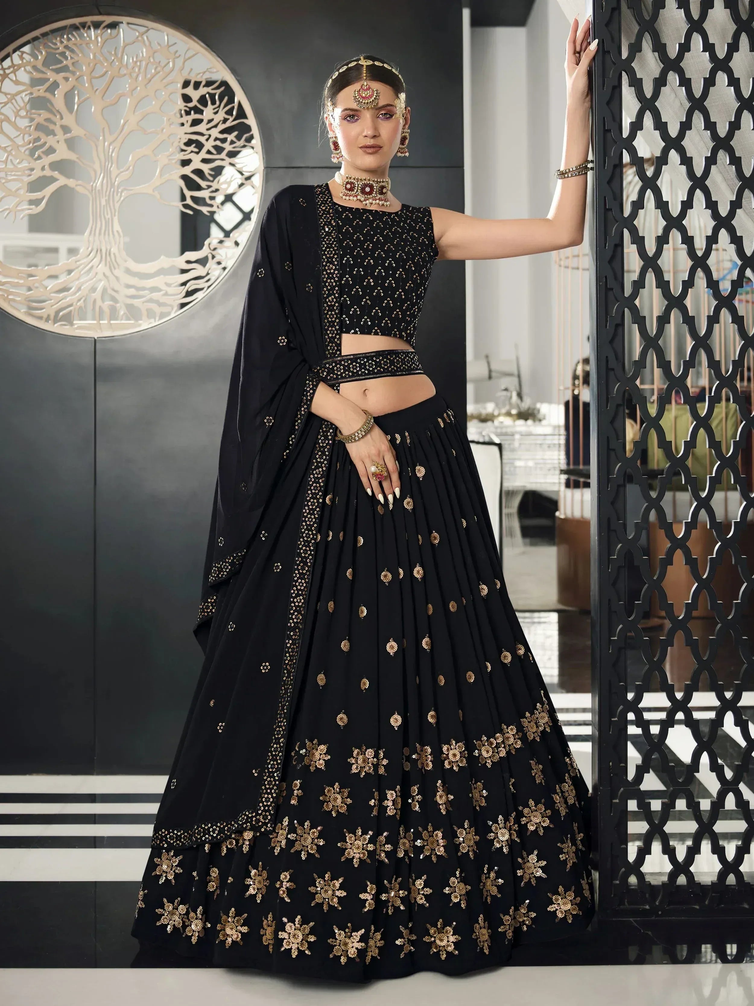Black designer lehenga choli with gold floral embroidery, perfect for Indian ethnic wear events.