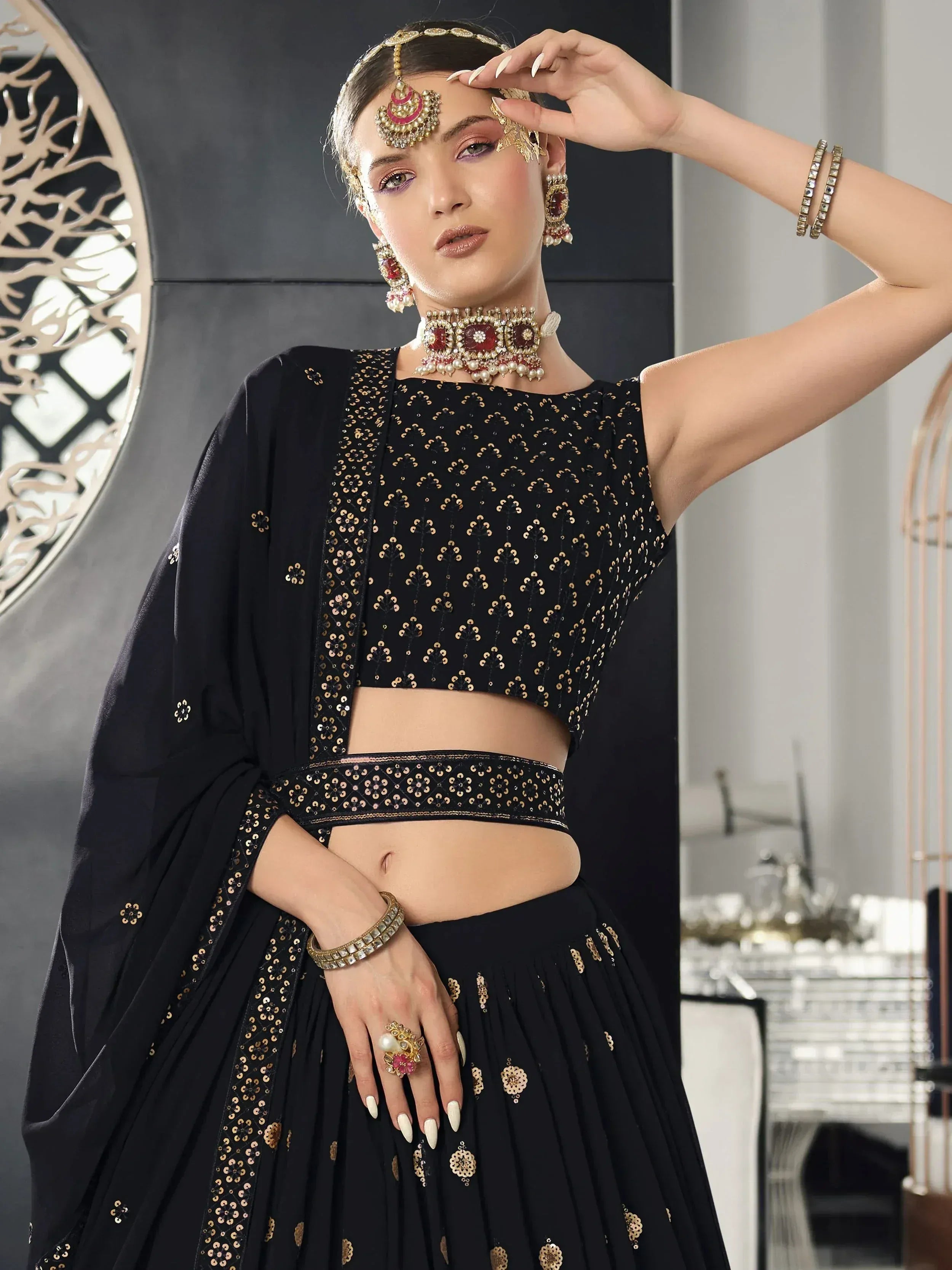 Black designer lehenga choli with gold embroidery, perfect for Indian ethnic wear and festive occasions.