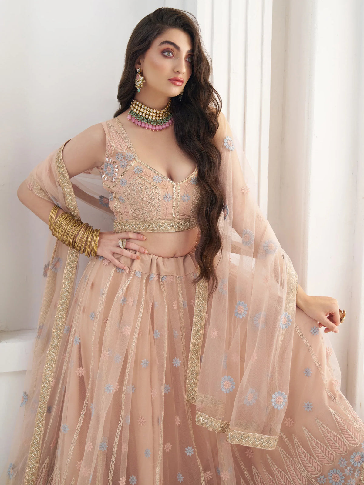 Lovable Peach Floral Embroidered Net Engagement Wear Lehenga Choli