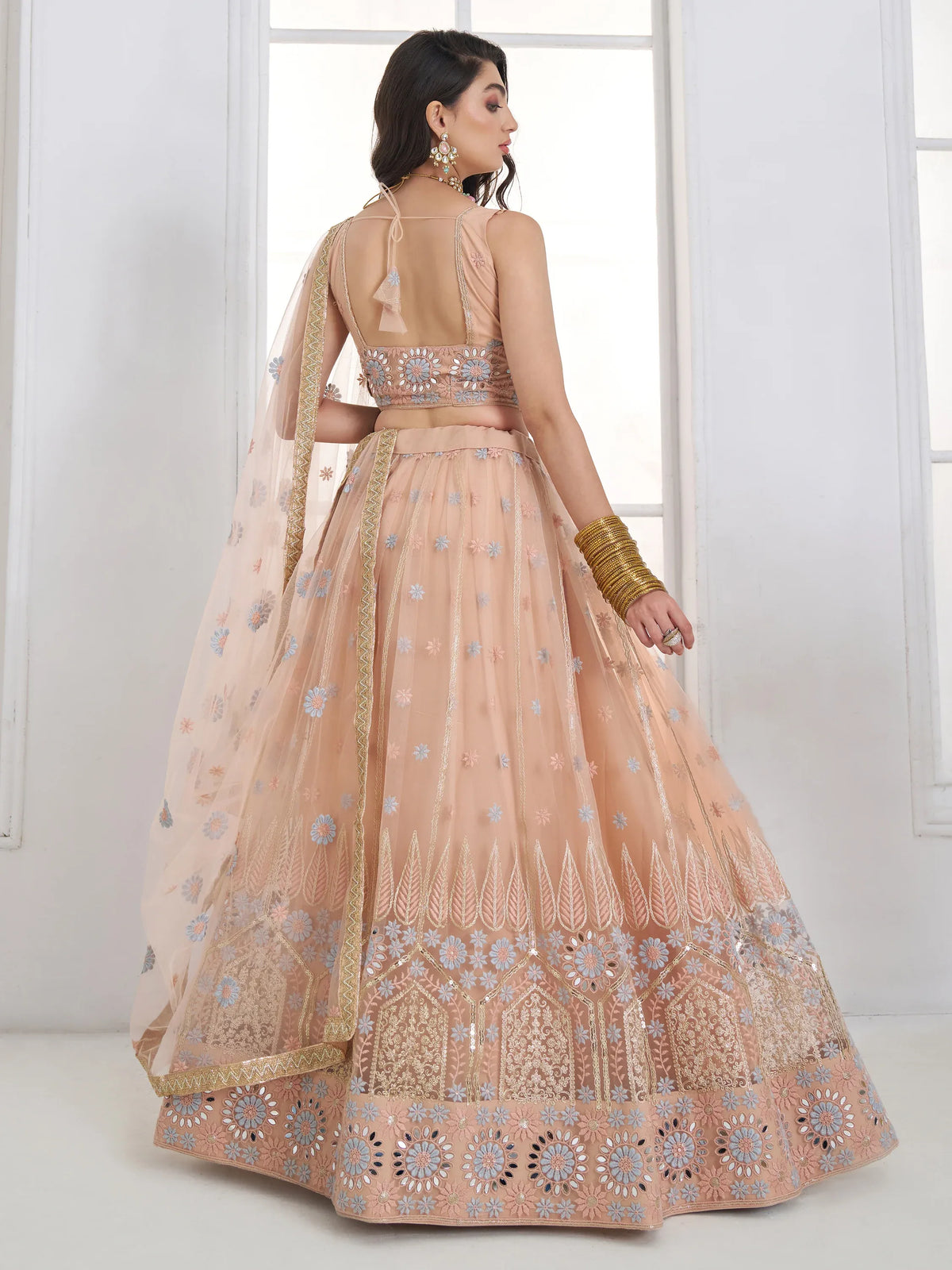Lovable Peach Floral Embroidered Net Engagement Wear Lehenga Choli