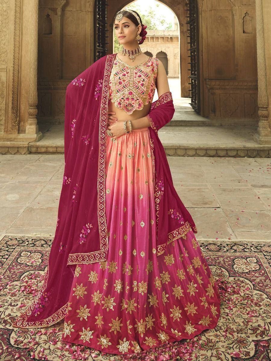 Pink and maroon embroidered lehenga choli with gold floral motifs, perfect for Indian weddings and festive occasions.
