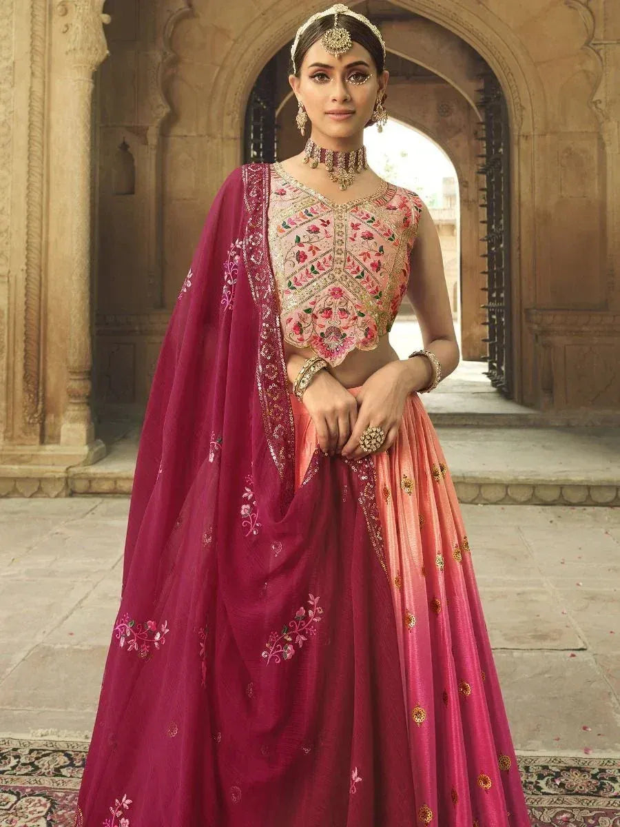 Pink and maroon embroidered lehenga choli with floral motifs, perfect for Indian weddings and festive occasions.