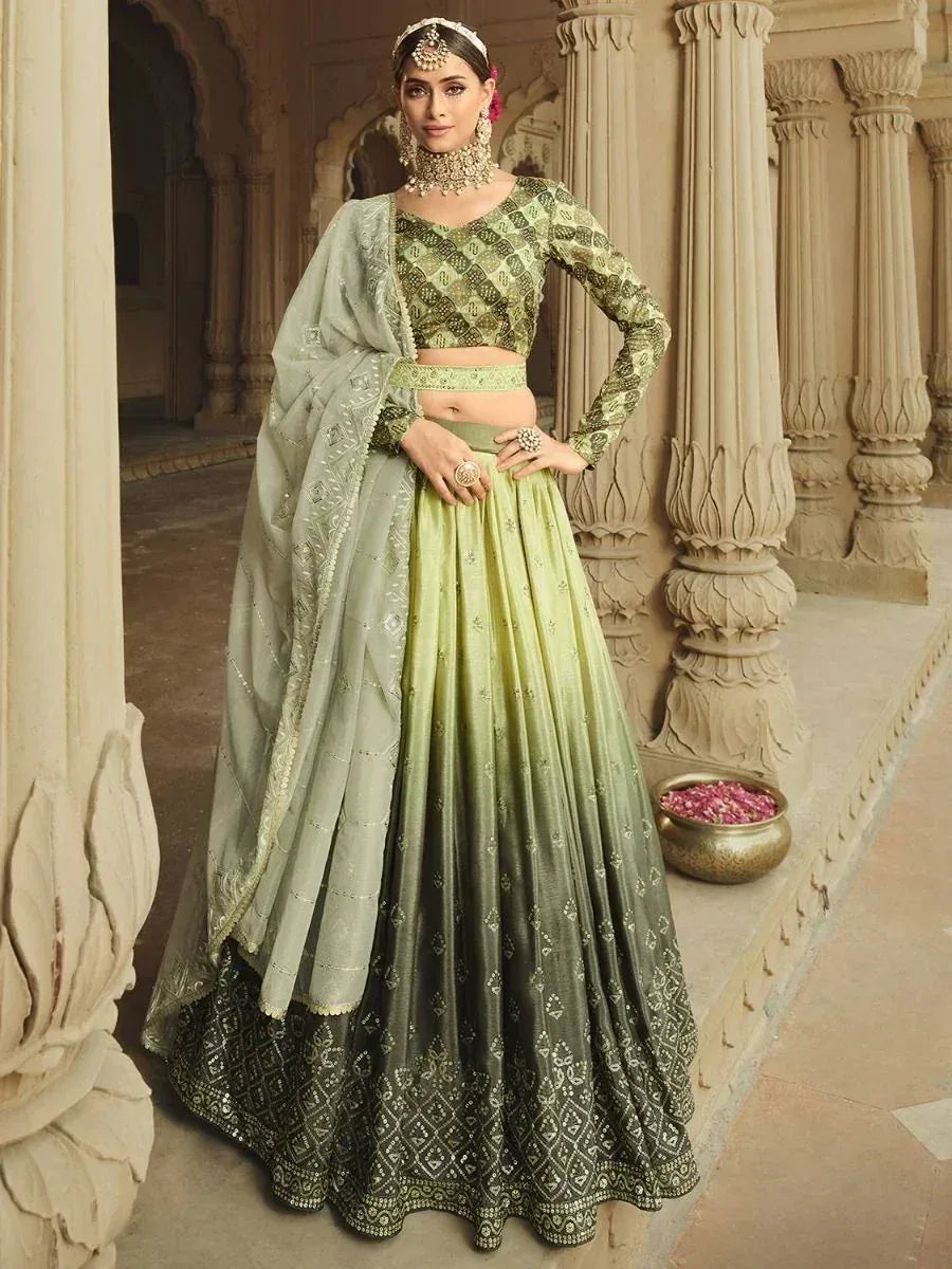Elegant green ombre lehenga choli with intricate embroidery, perfect for Indian weddings and festive occasions.
