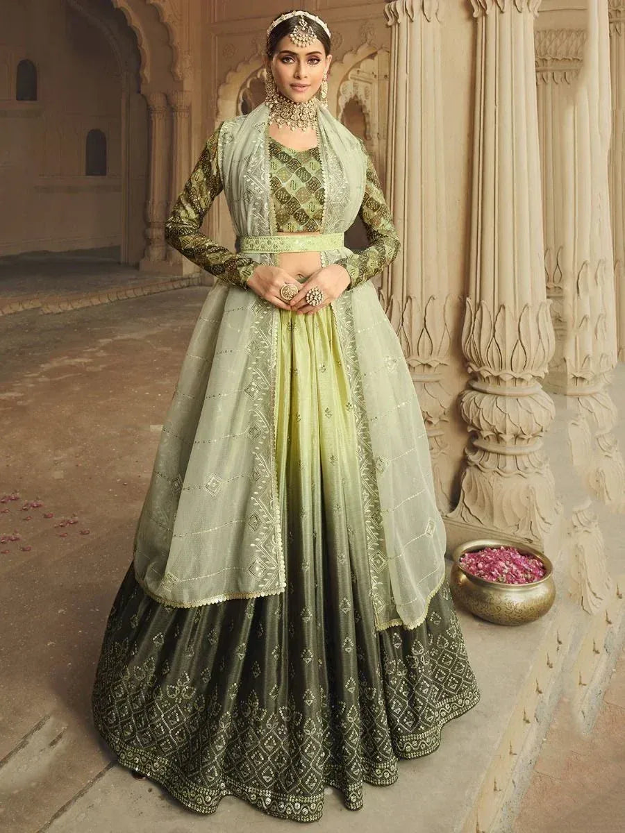 Elegant green designer lehenga choli with intricate embroidery, perfect for Indian weddings and festive occasions.